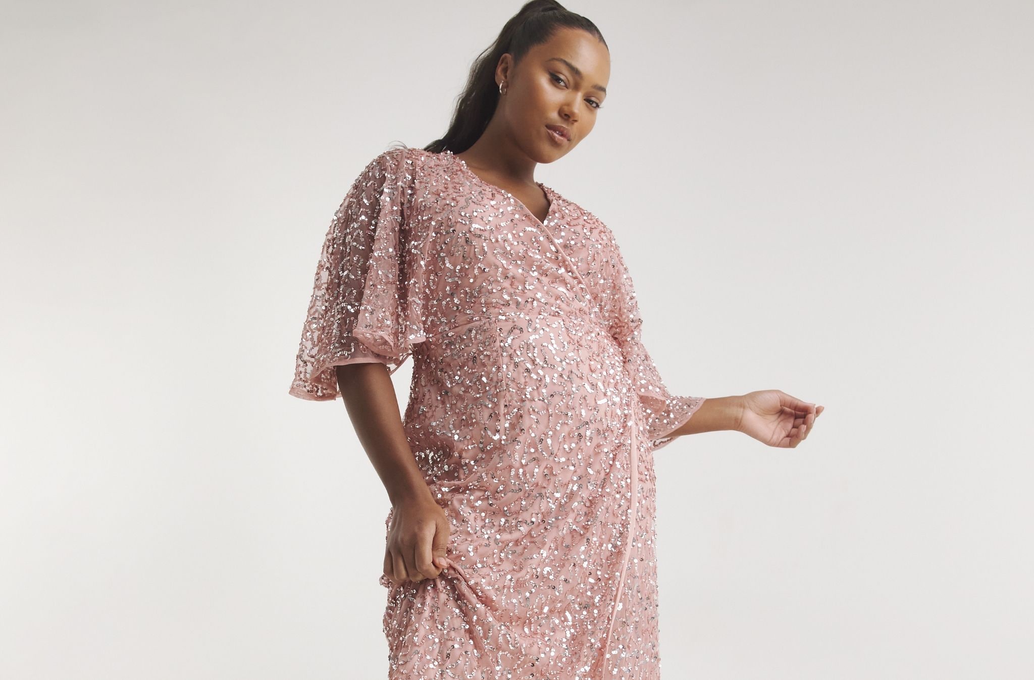 Model wearing a long pink patterned dress