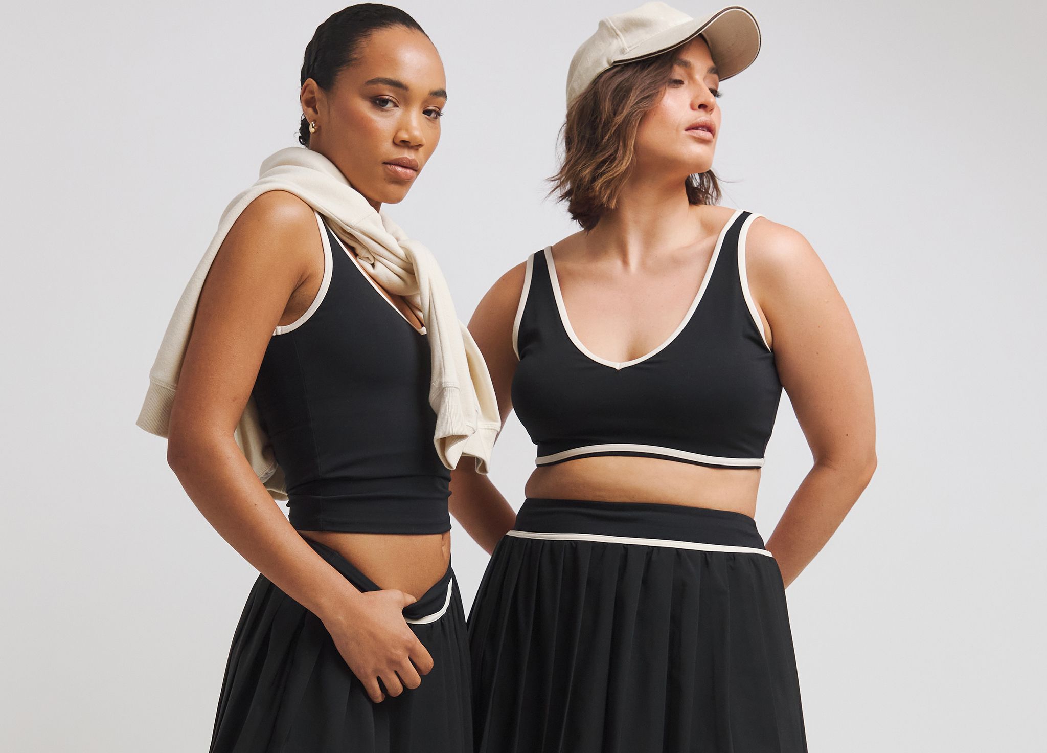 Two models wear sports tops and skirts by TALA