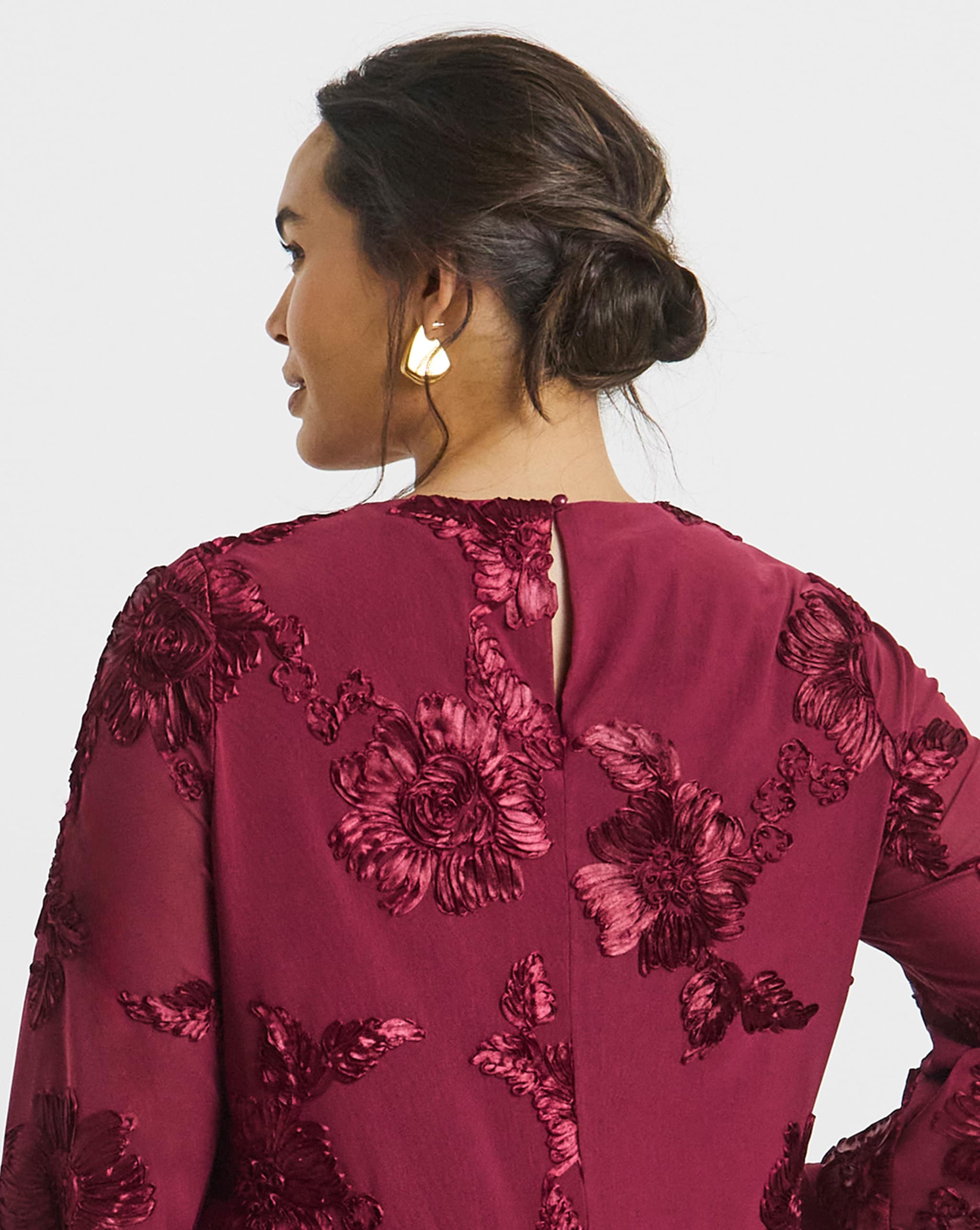 Model wears earrings  had dark red top