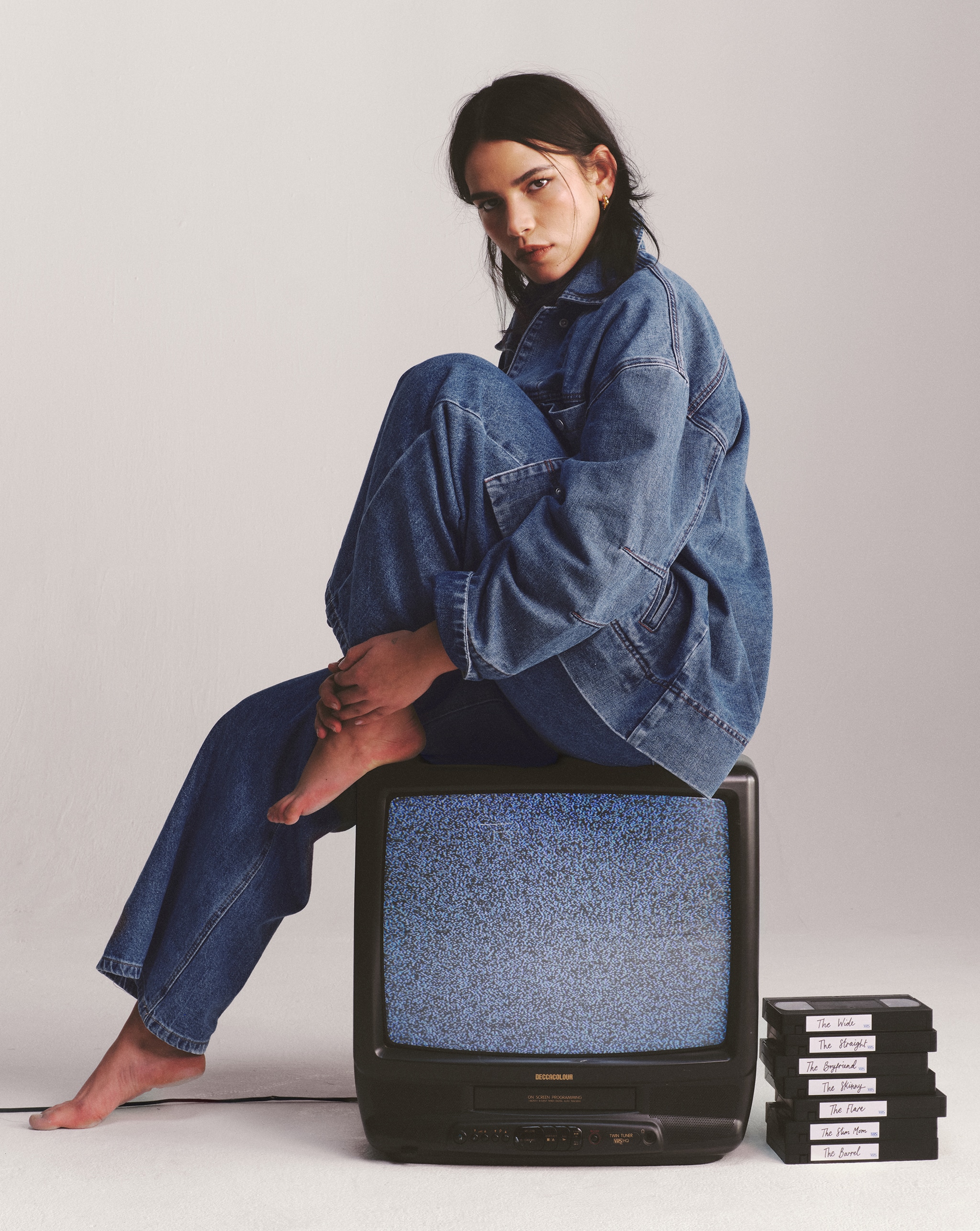 Model wears denim shirt and jeans