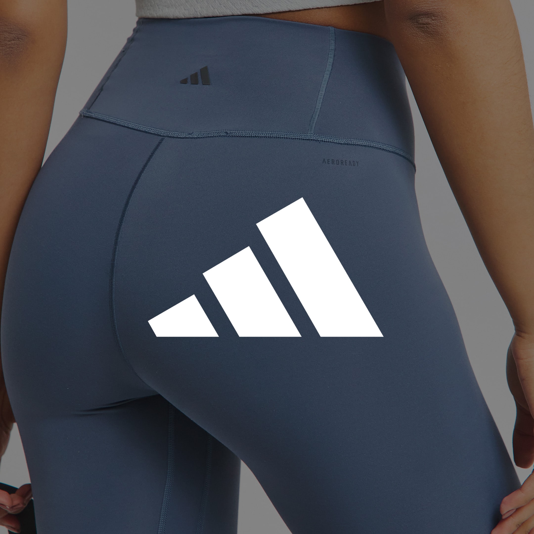 Model wearing blue adidas leggings
