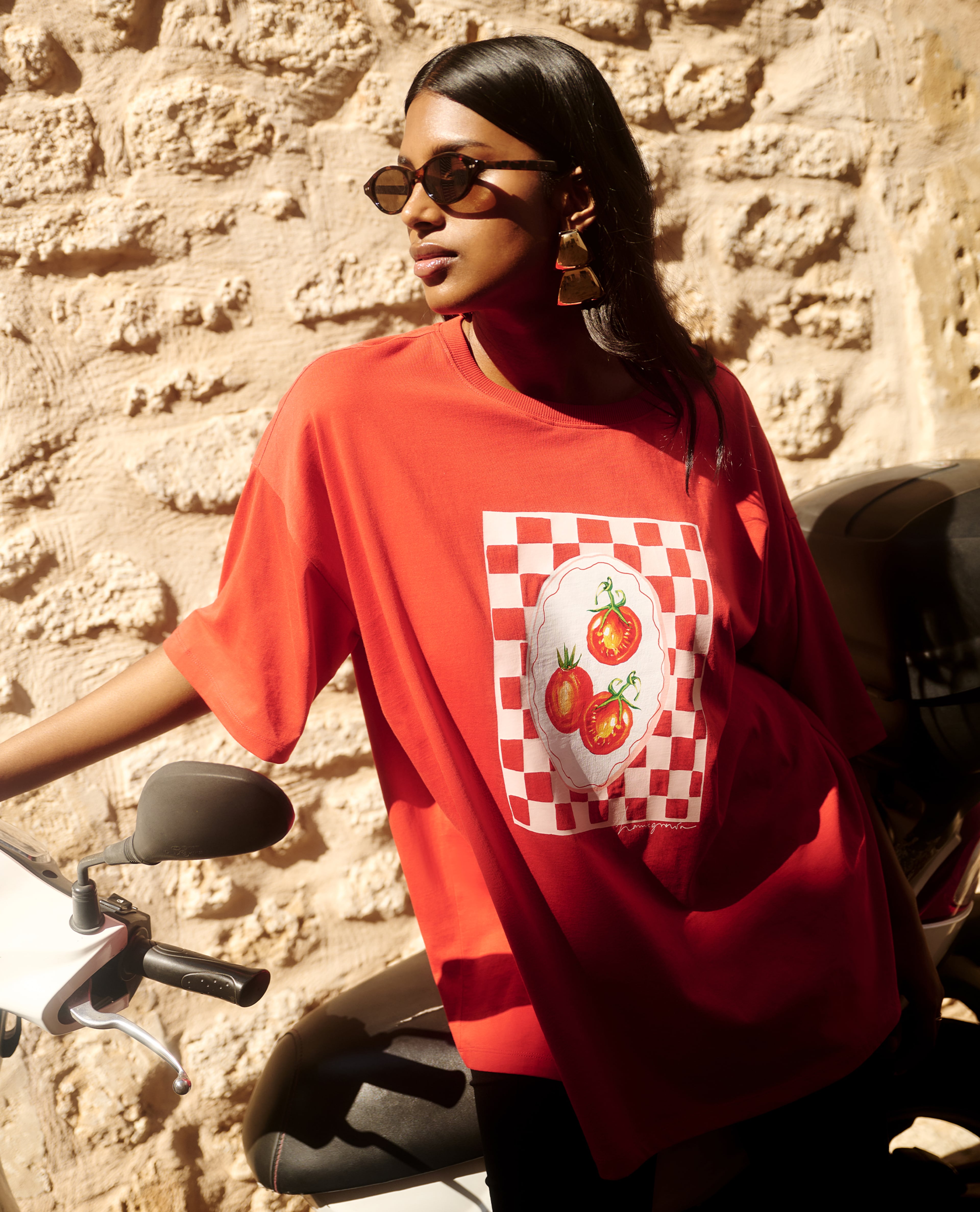 Model wears red graphic t-shirt