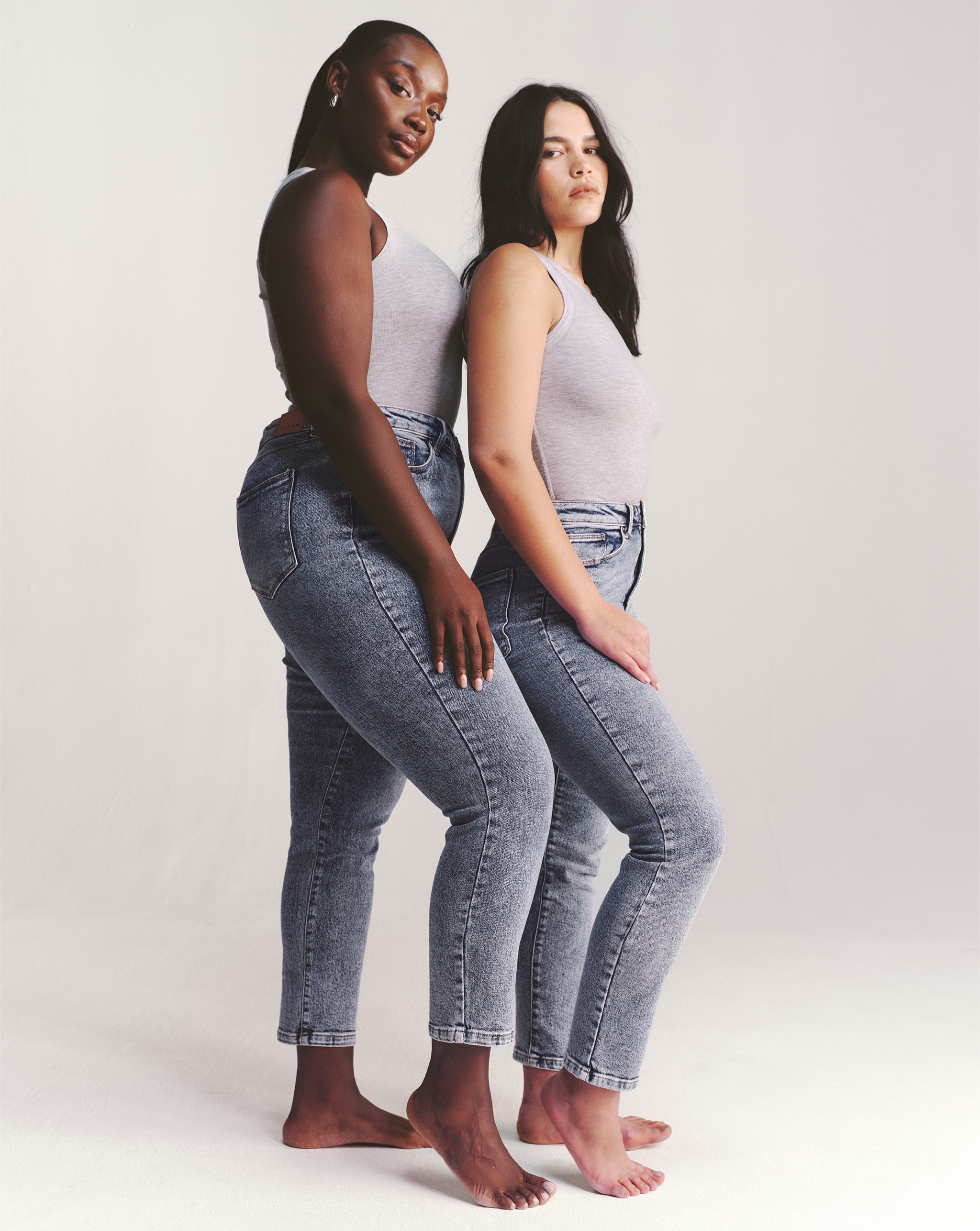 Two models wear slim high-waisted jeans
