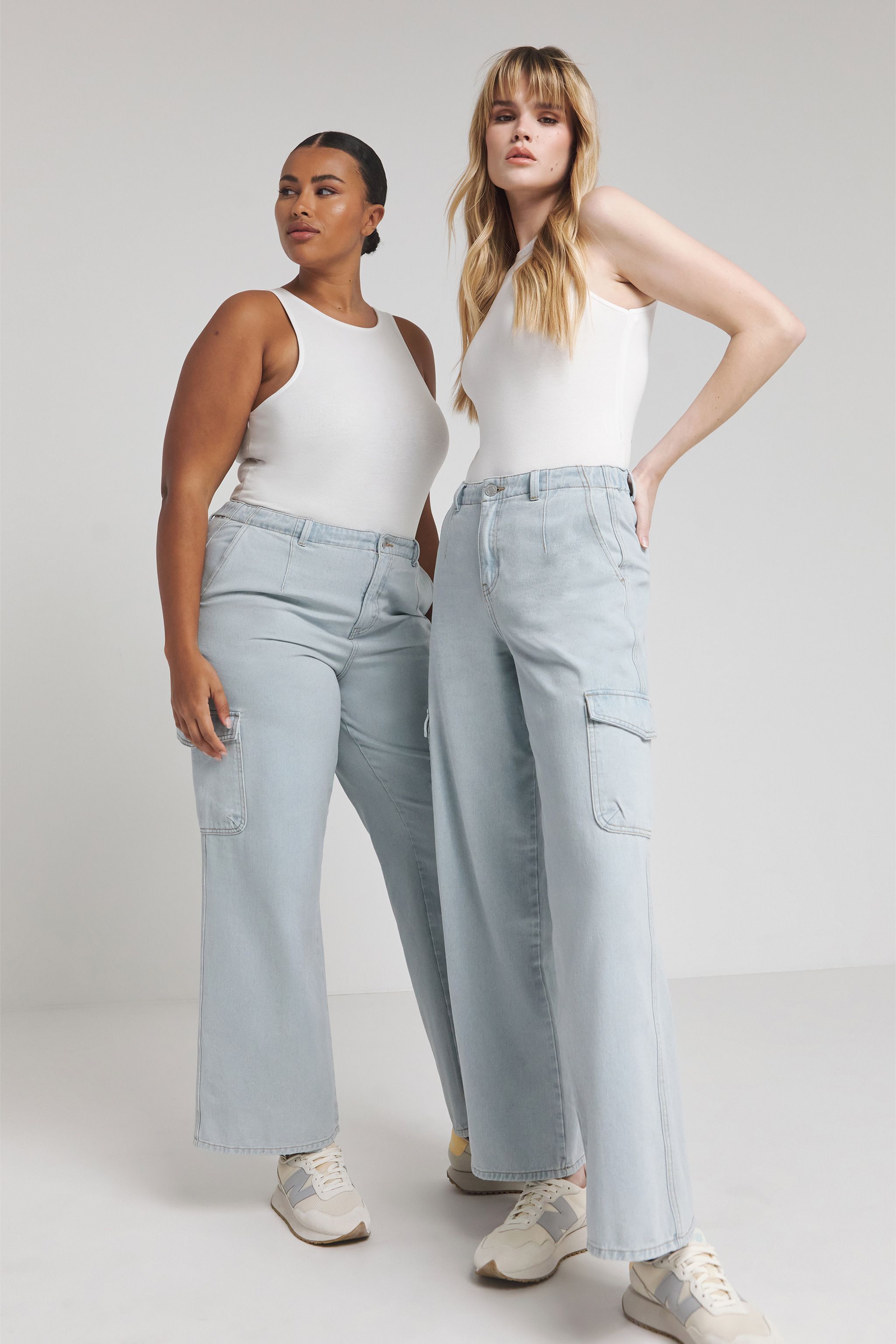 Two models wearing cargo jeans and vest