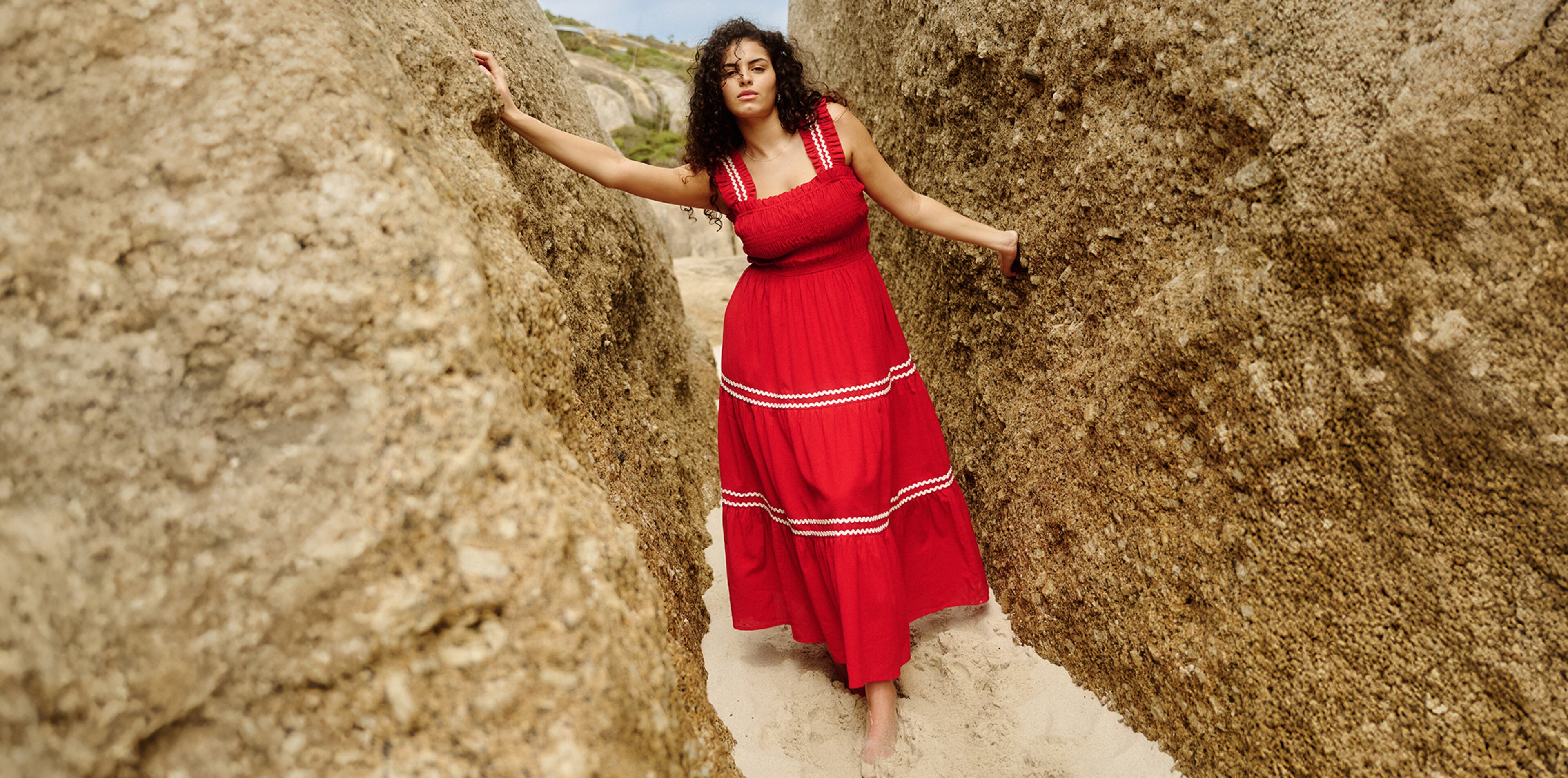 Model wears red maxi dress