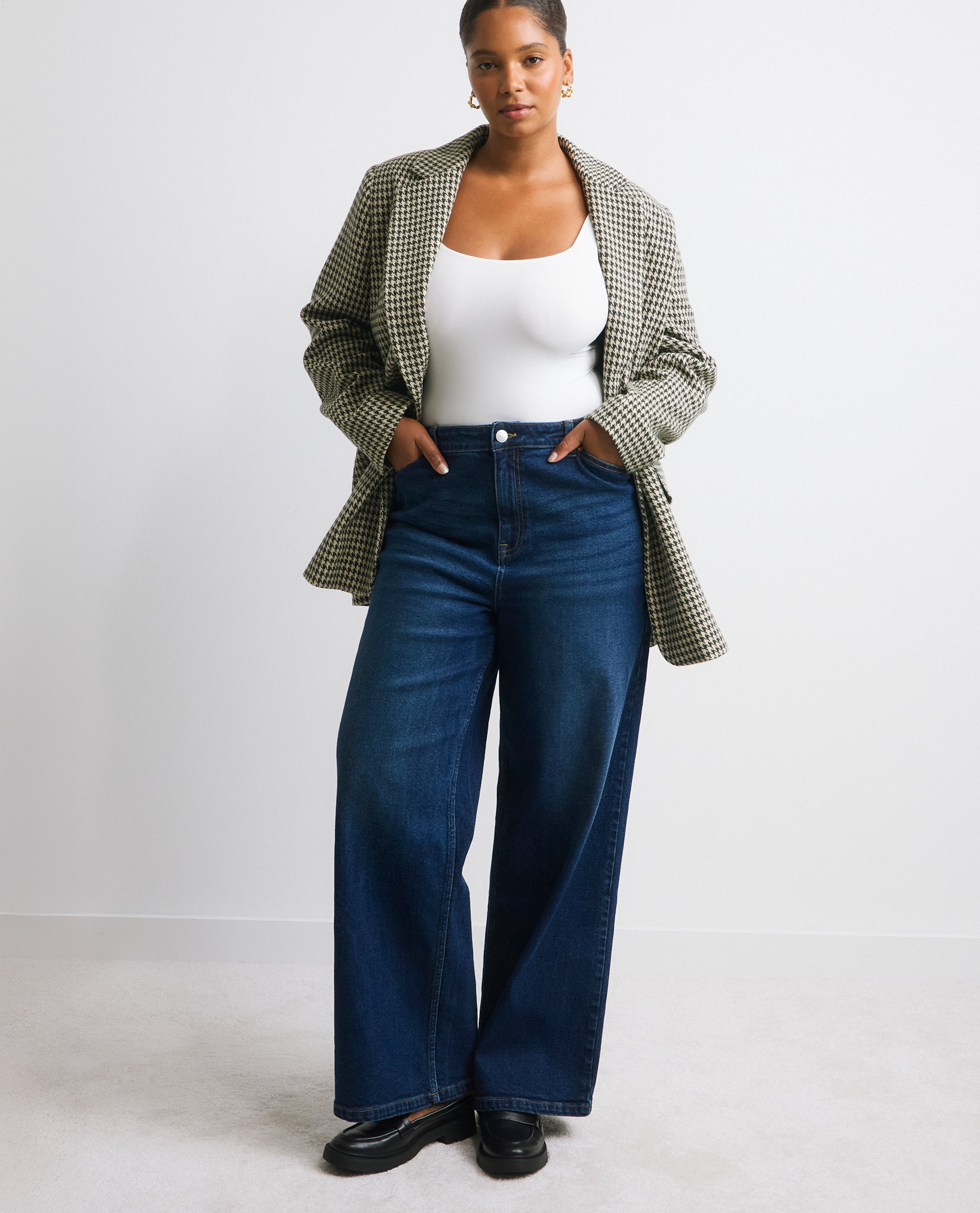 Model wears new season blazer and wide-leg jeans