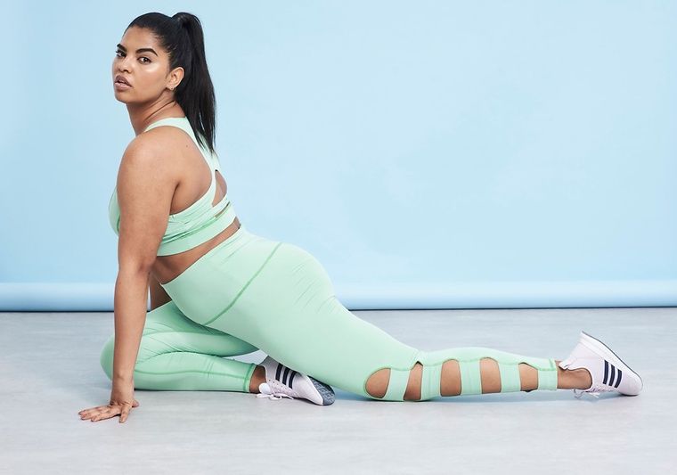 model stretching on floor wearing activewear