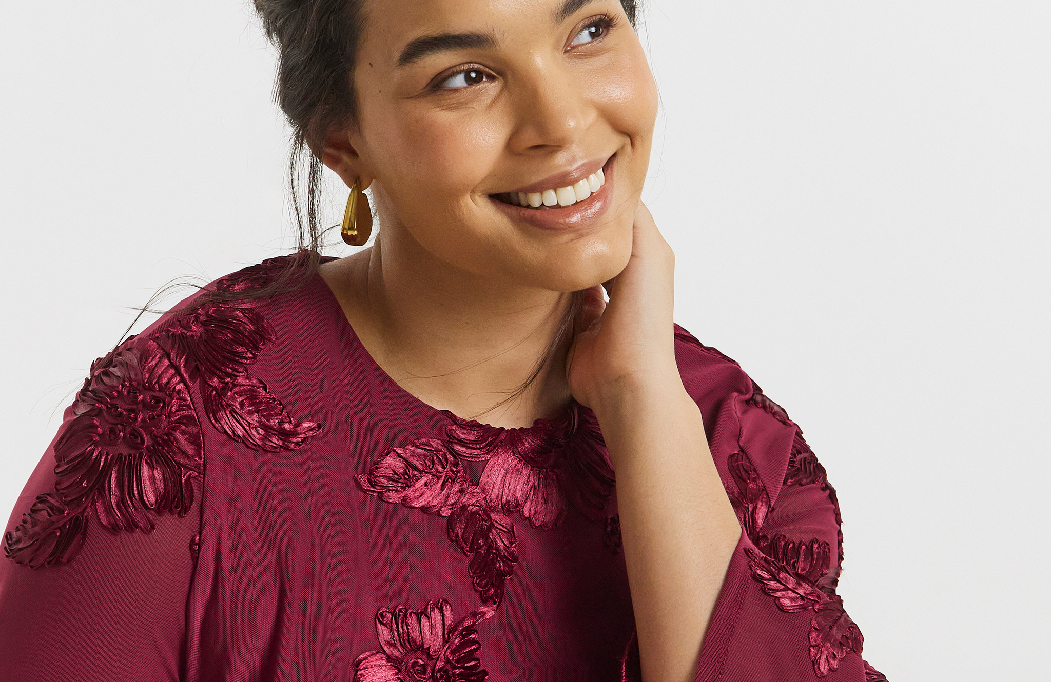 Model wears earrings had dark red top