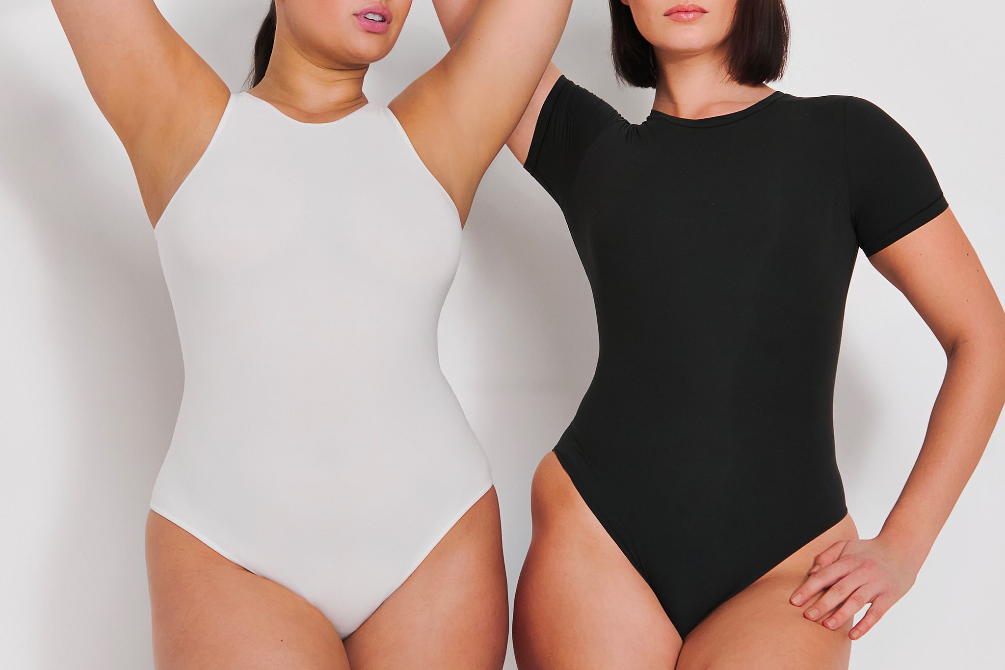 Two models wearing bodysuits