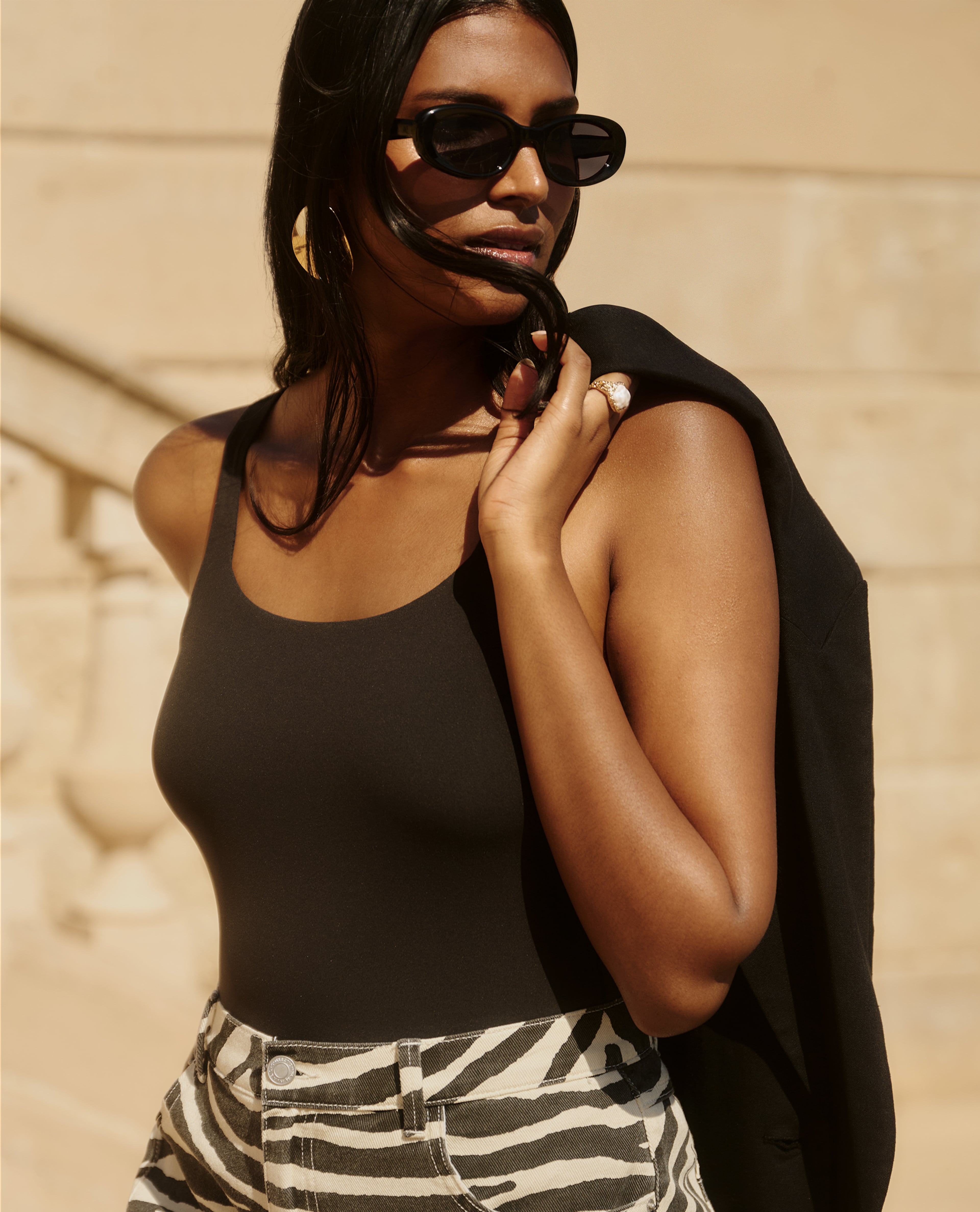 model wearing glasses top over shoulder