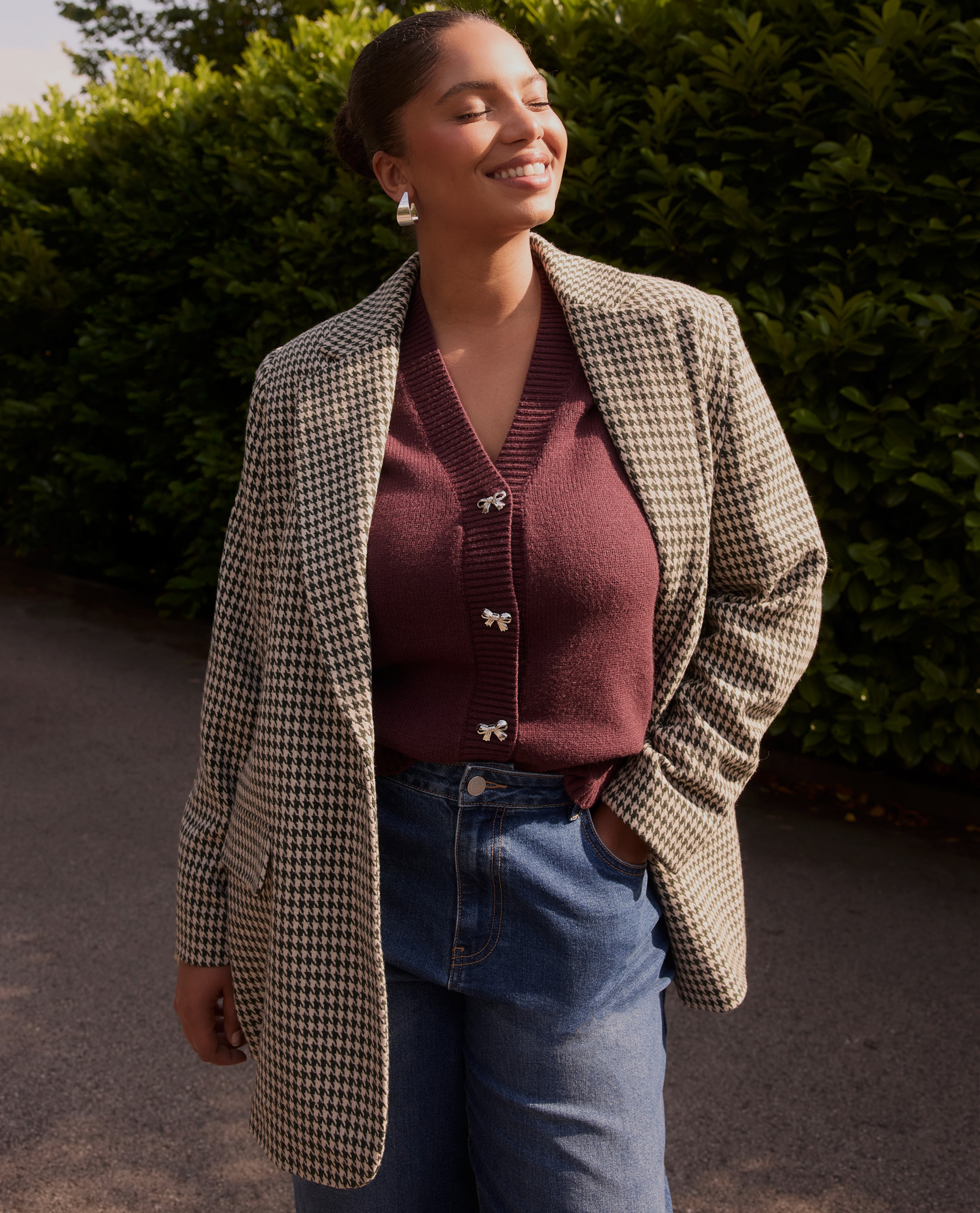Model wearing brown check jacket with brown top