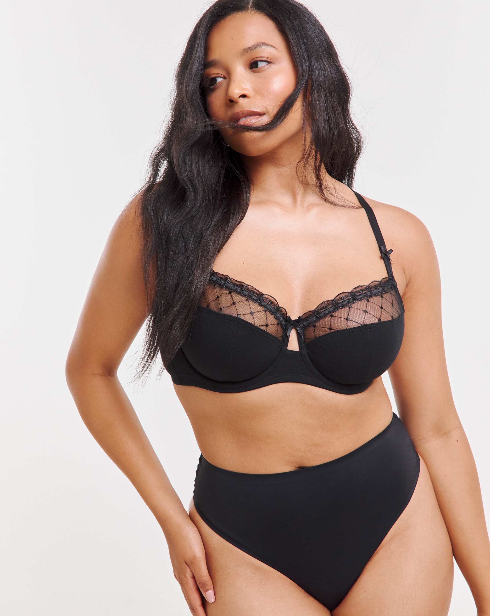 A model wearing a black lacy balcony bra