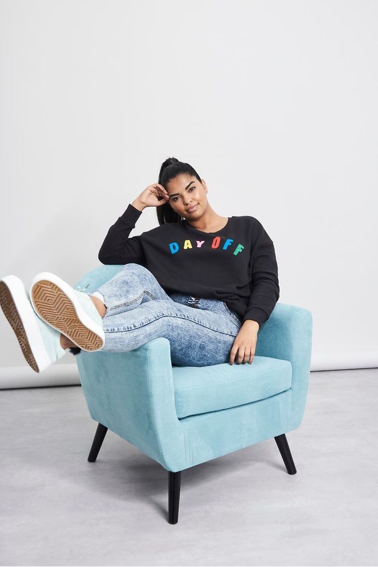model sitting on armchair