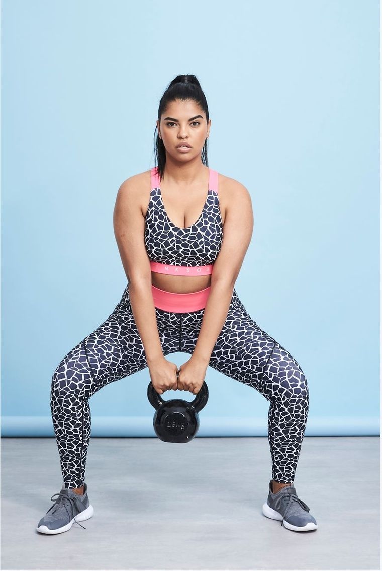 Model doing kettlebell swings