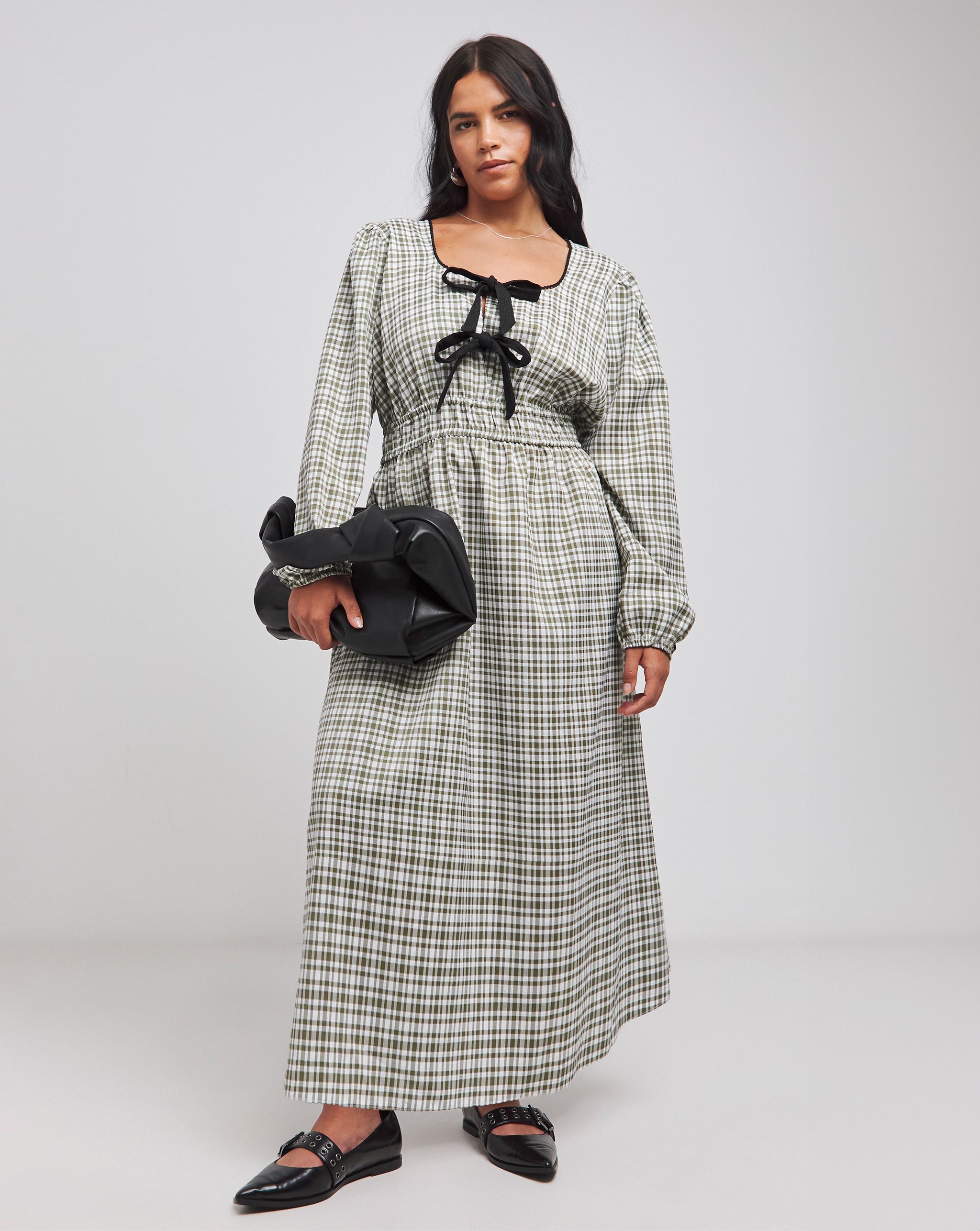 Model wears bow detail check print dress
