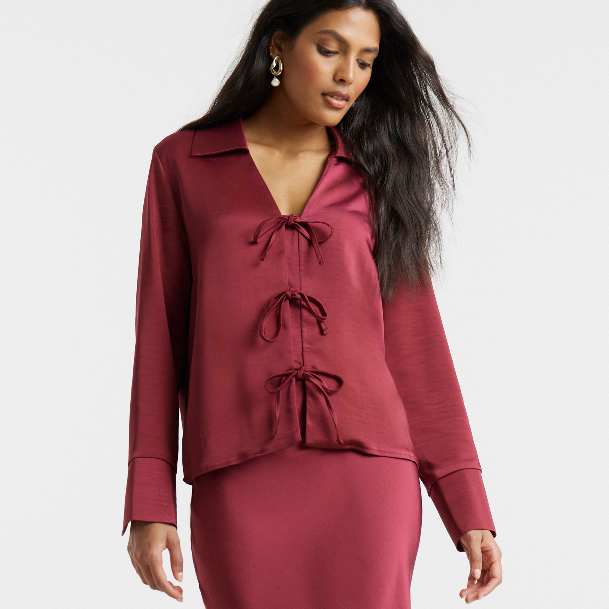 Model wears red tie-front top and matching skirt from Flounce London