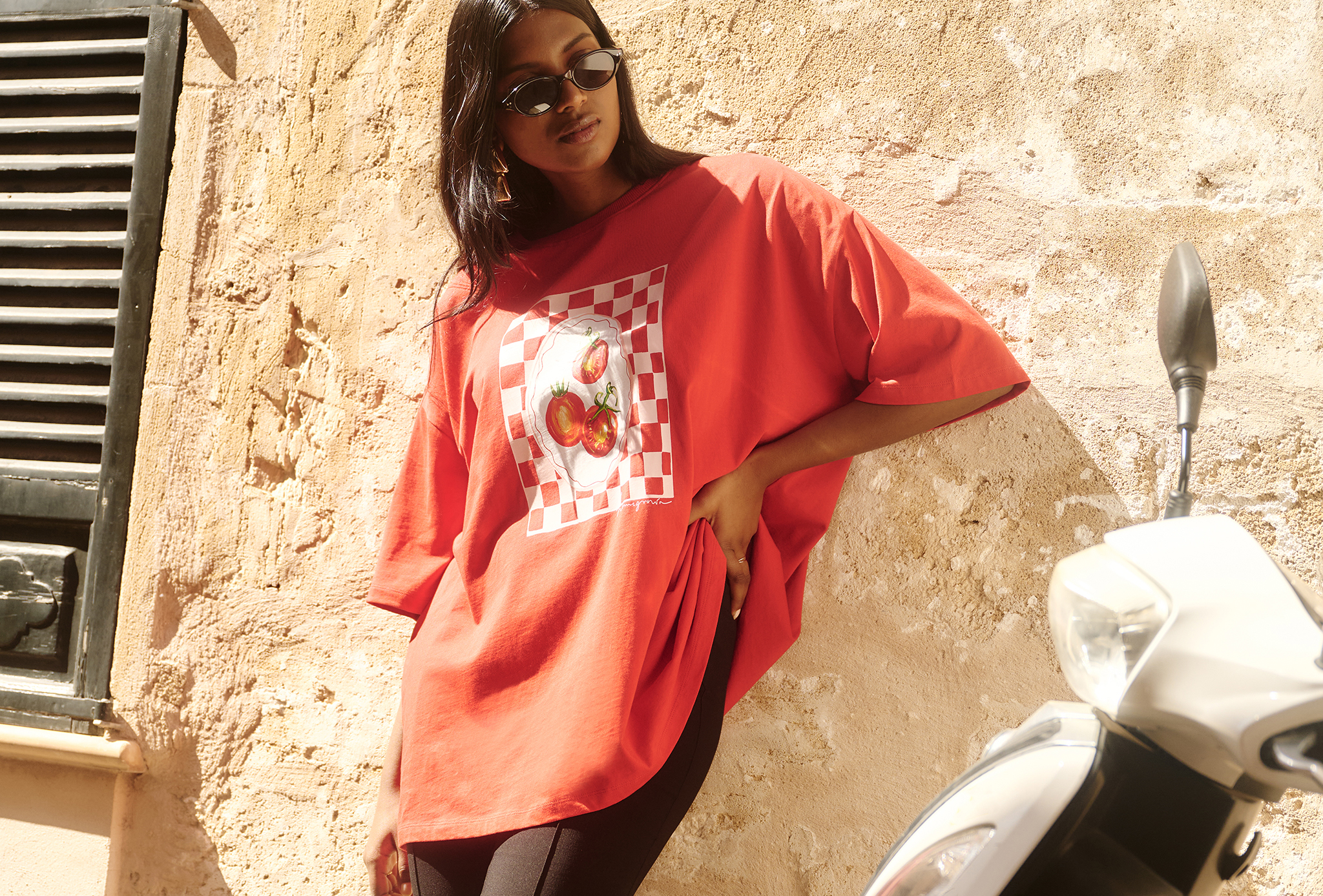 Model wears red tomato graphic tee