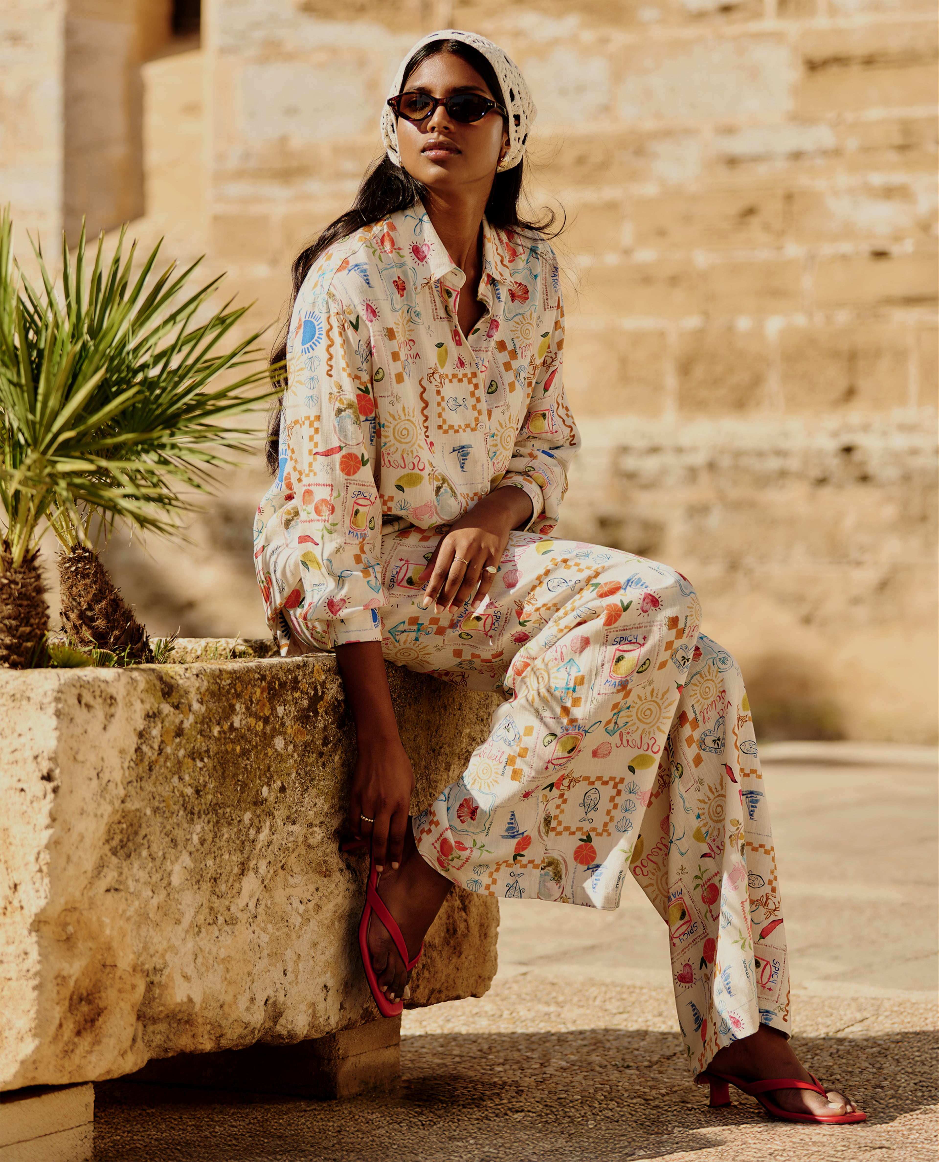 Model wears multi-coloured print jumpsuit
