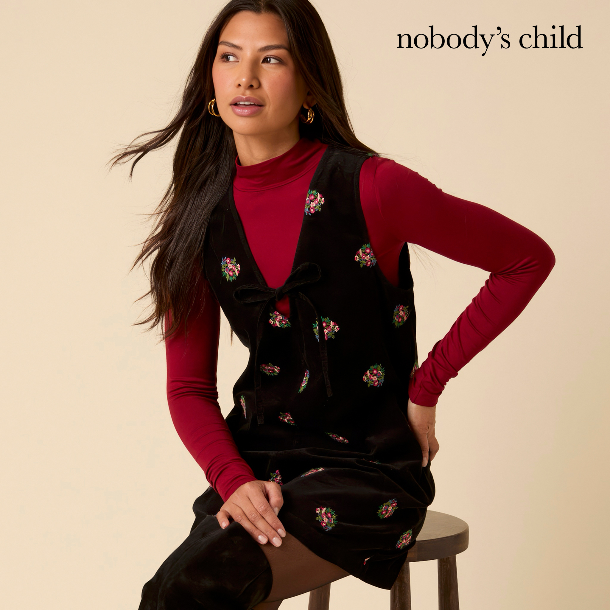 Model wears floral detail dress and high-neck top from Nobody's Child