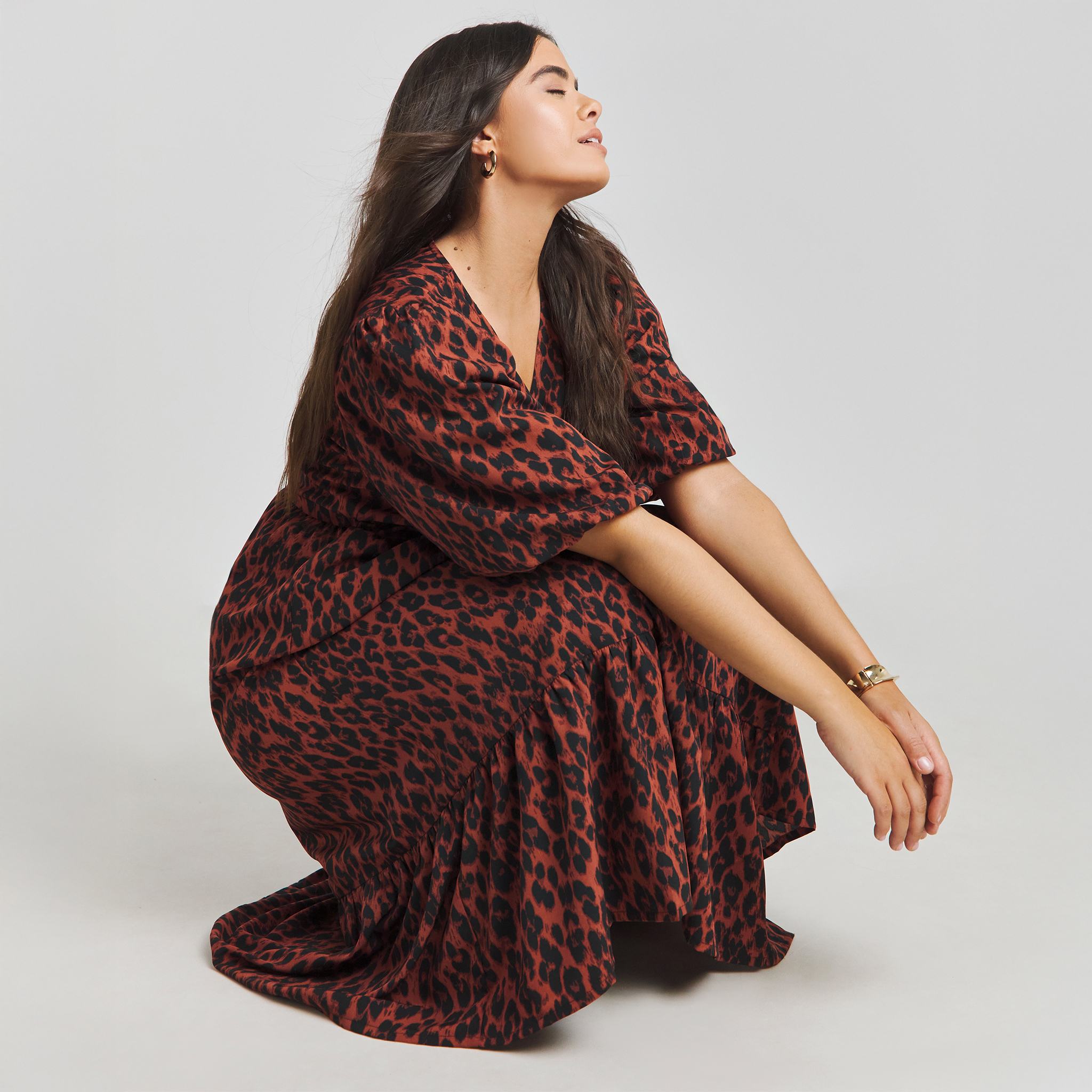 Model wears red leopard print dress