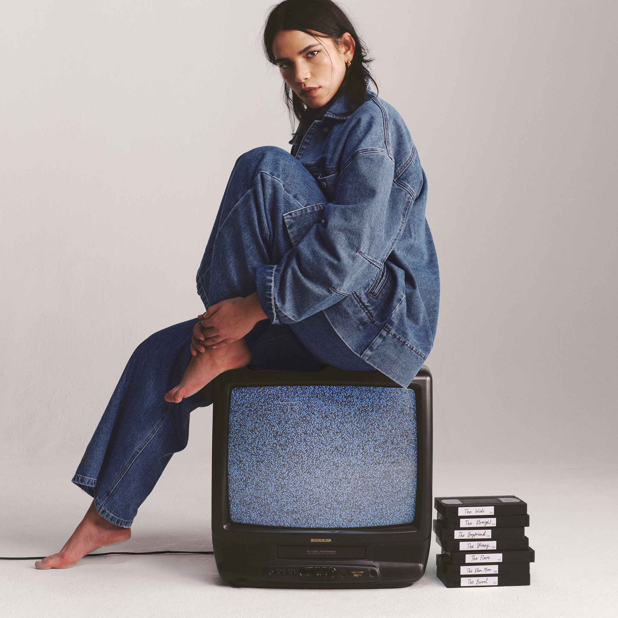 Model wears denim shirt and jeans