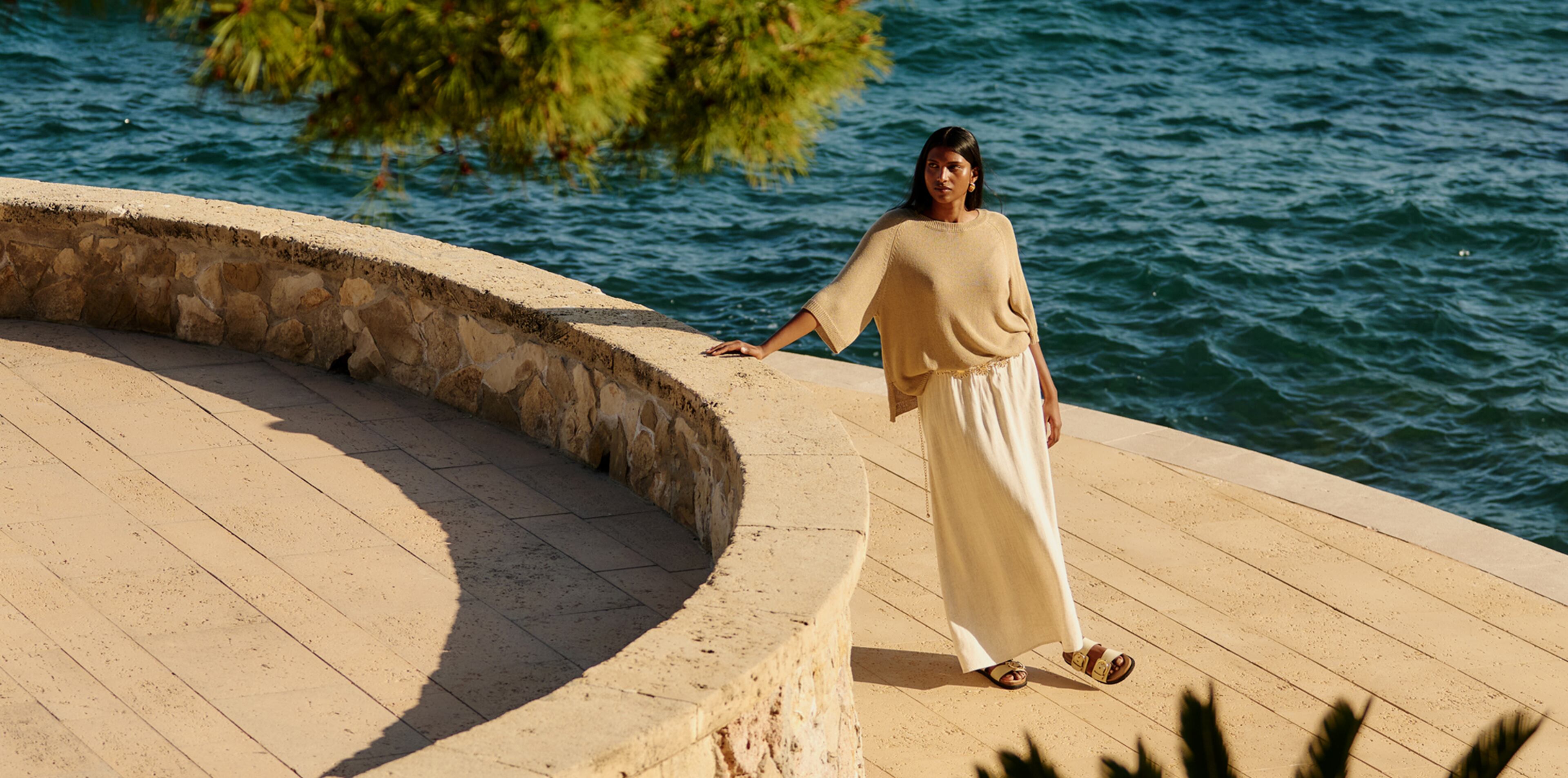 Model wears summer knit and linen maxi skirt