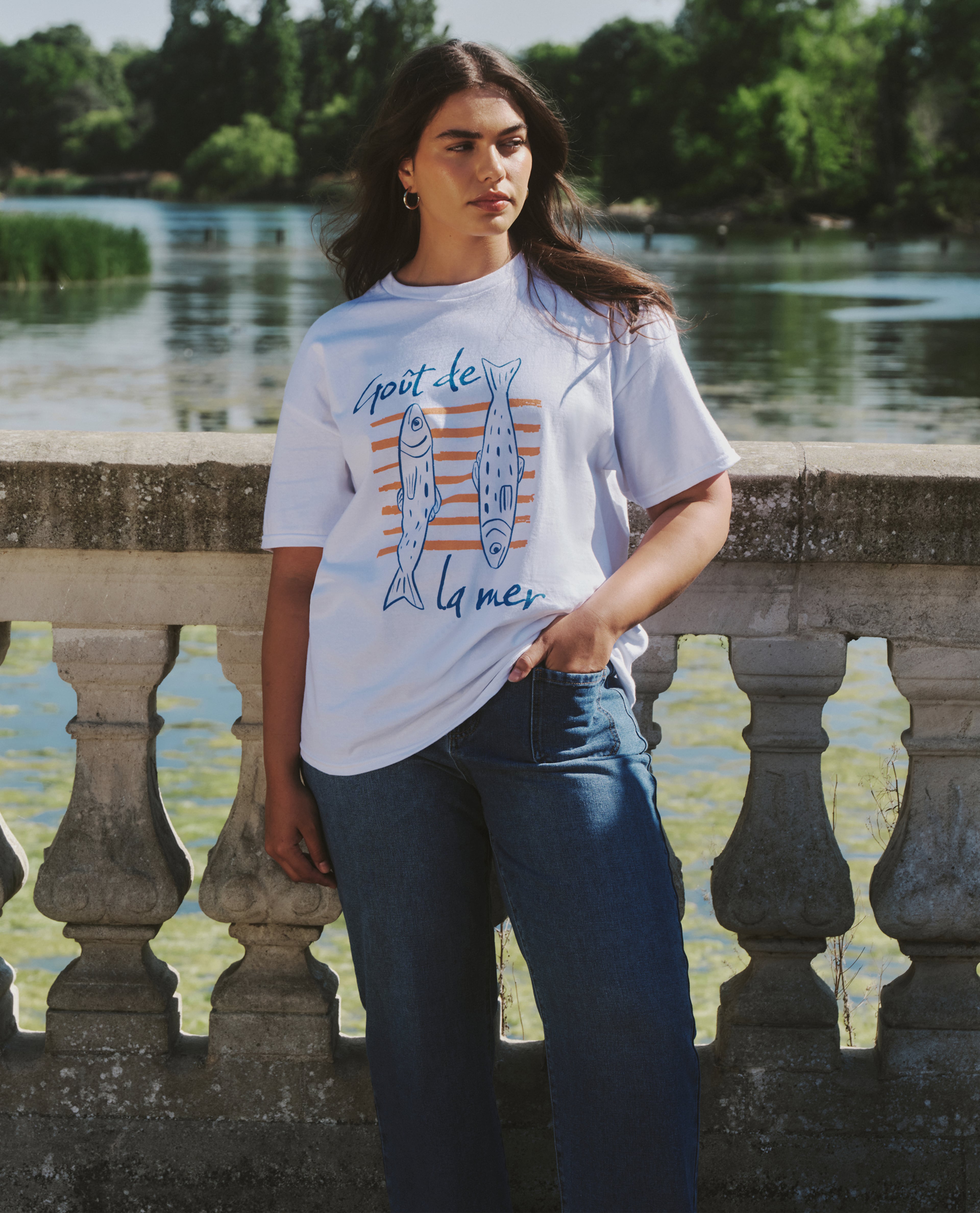 Model wears graphic tee in white
