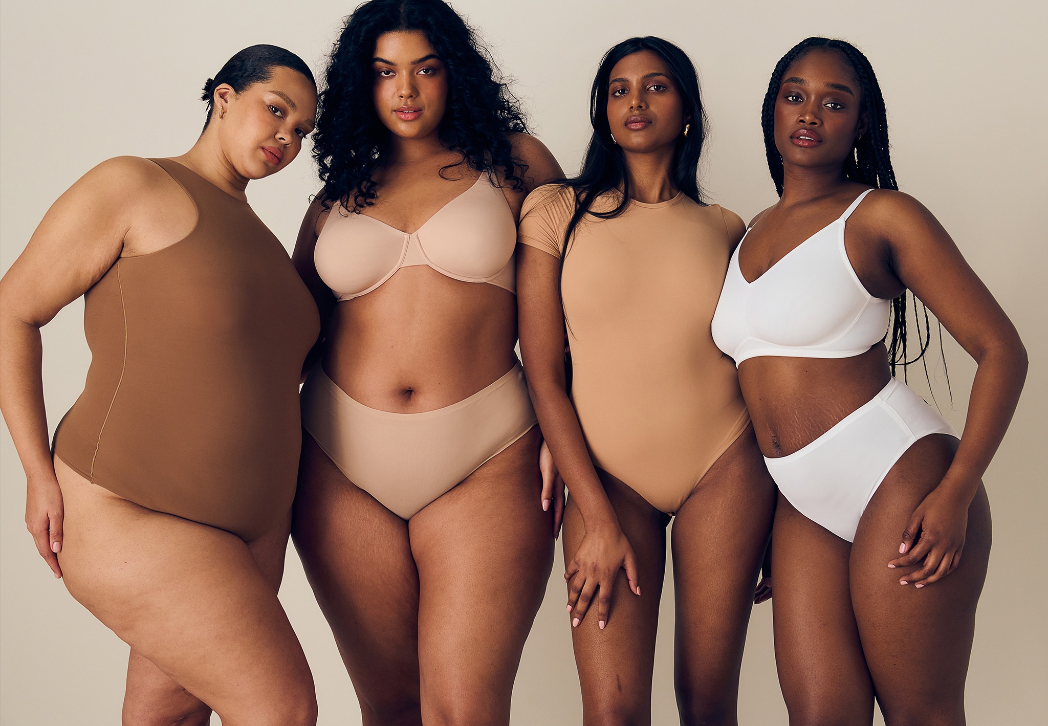 Four models wear various shapewear products