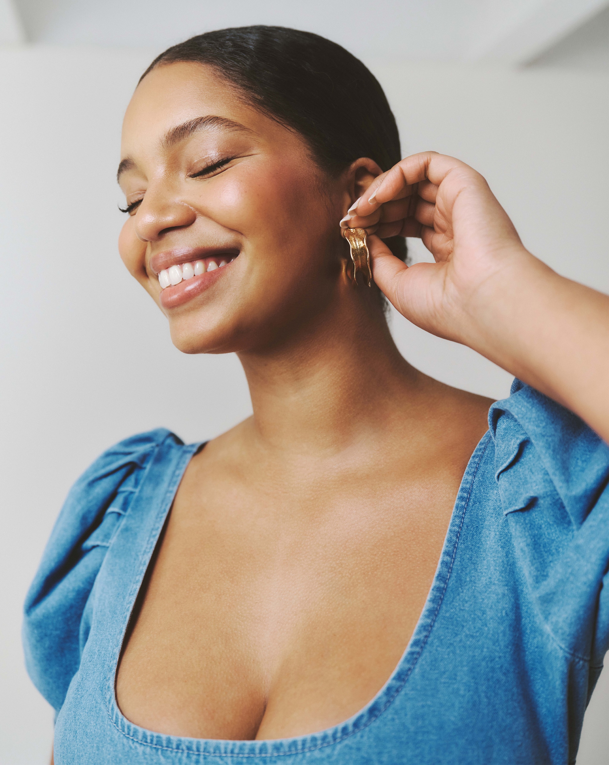 Model putting earrings in