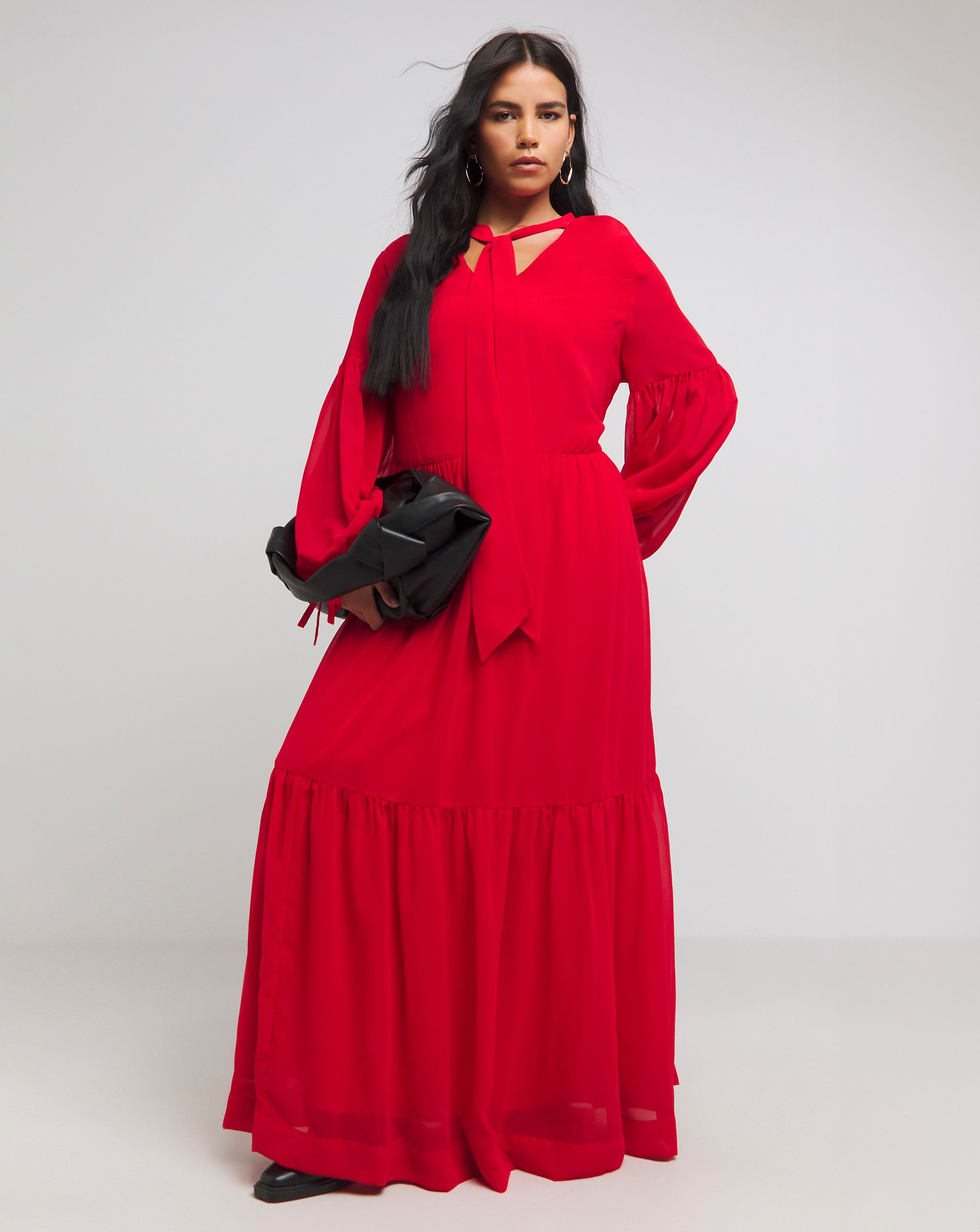 Model wears red maxi dress with neck-tie detail