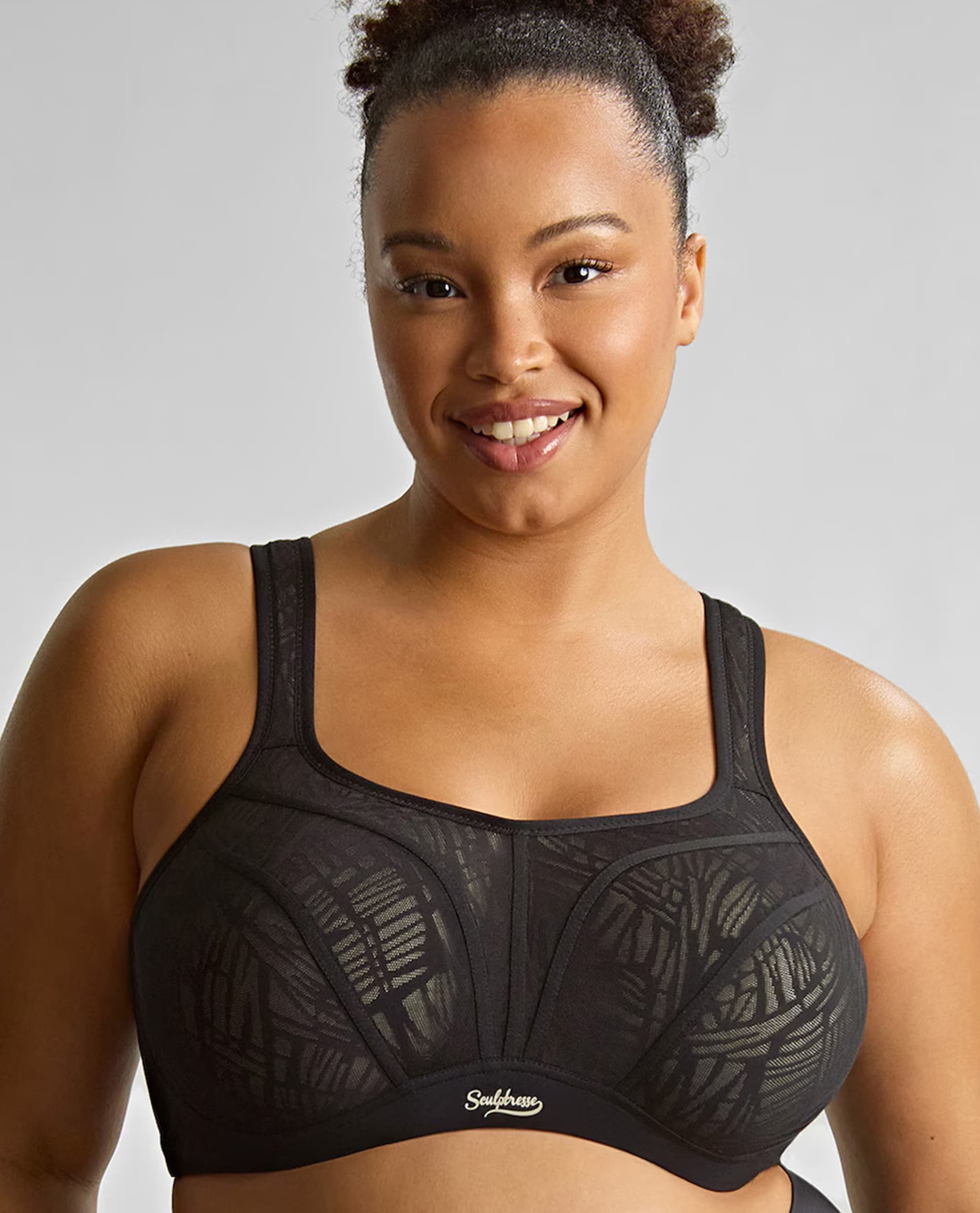 Model is wearing a Sculptresse by Panache non padded wired sports bra in black