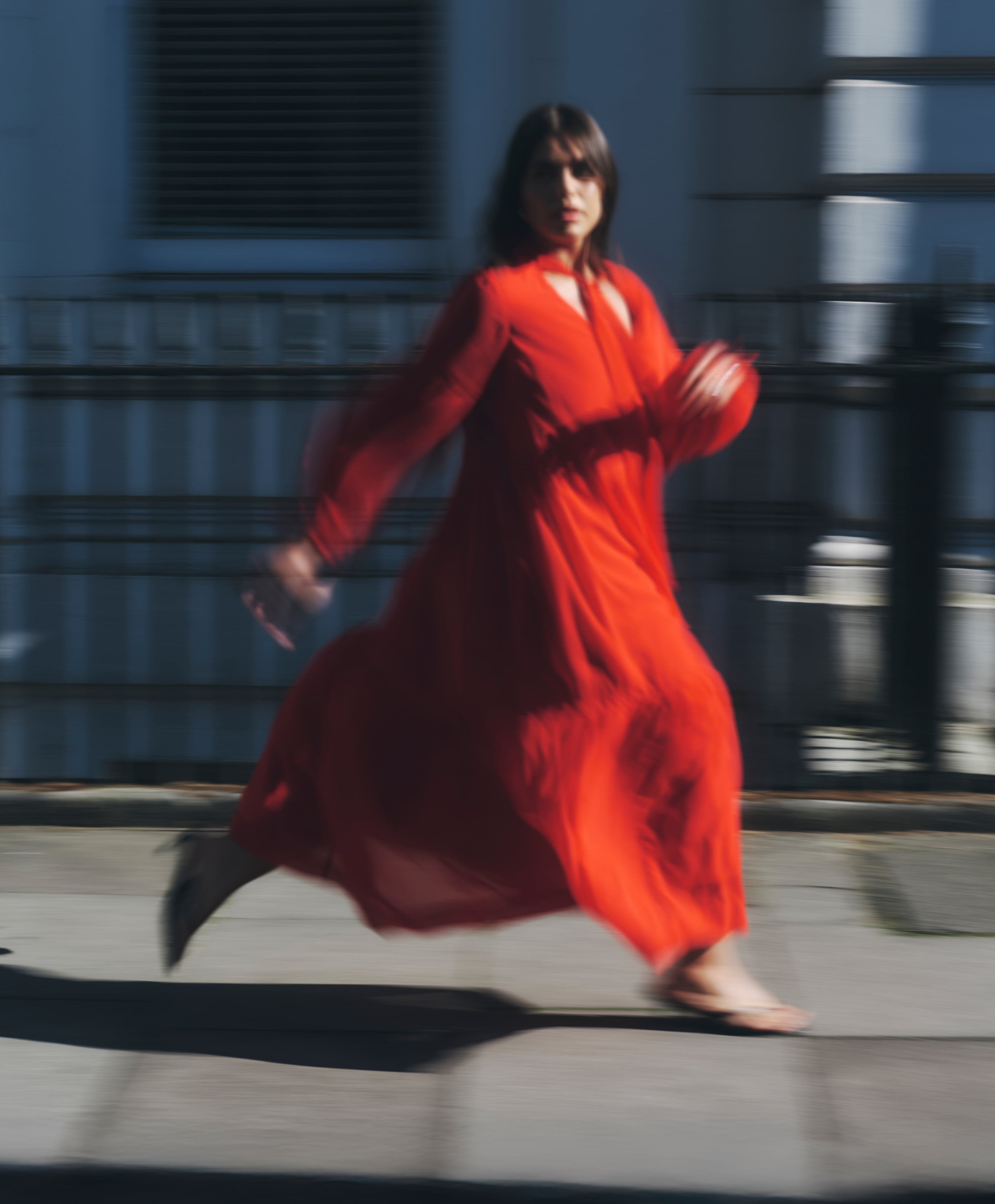 model running wearing red dress
