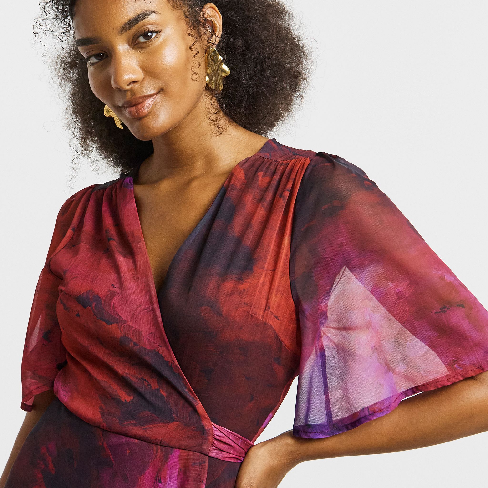 Model wears party dress from Hope & Ivy