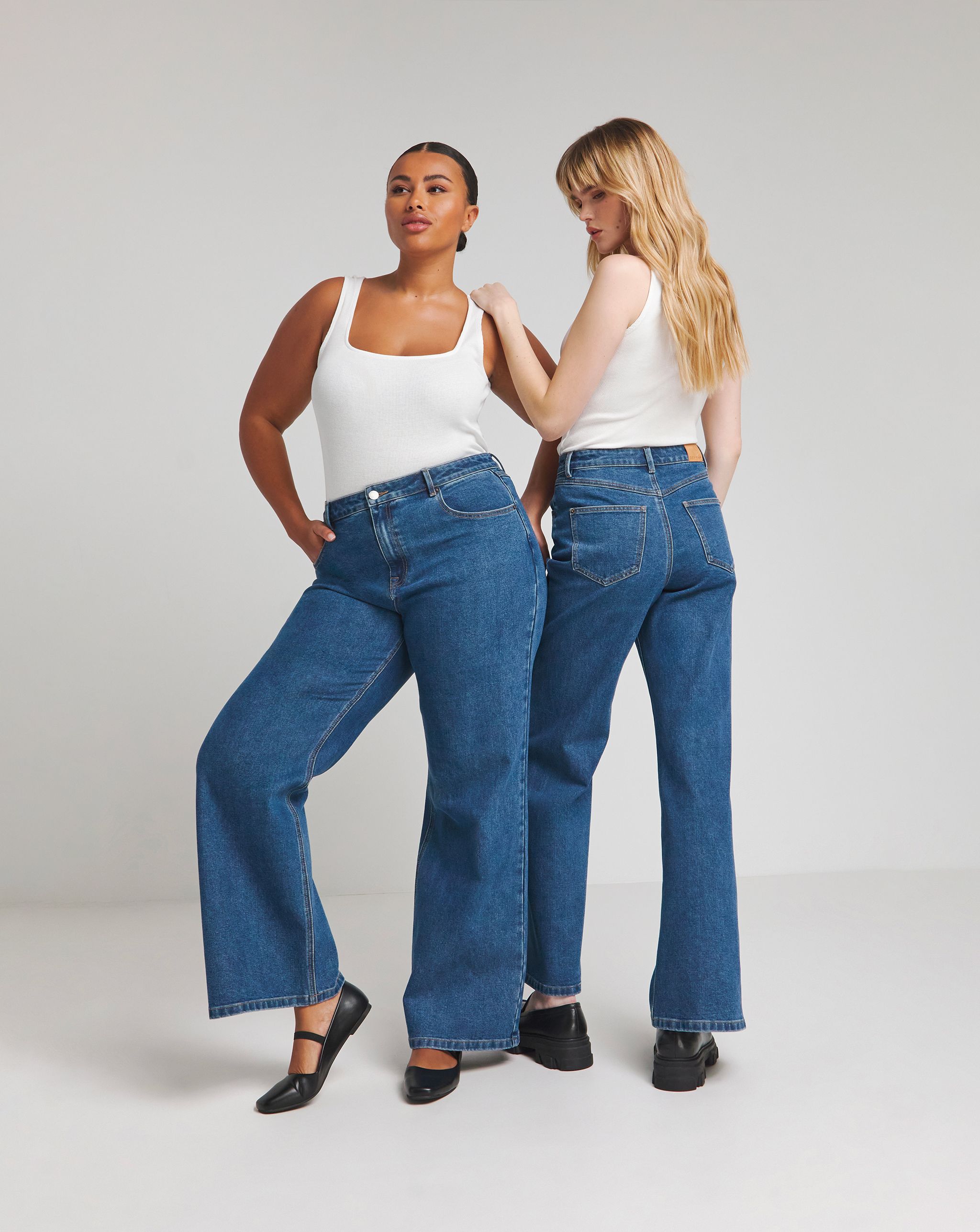 Two models wearing wide leg jeans