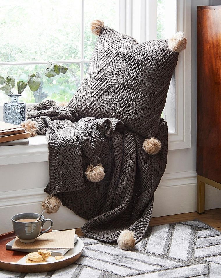 pom pom throw and cushion on window ledge