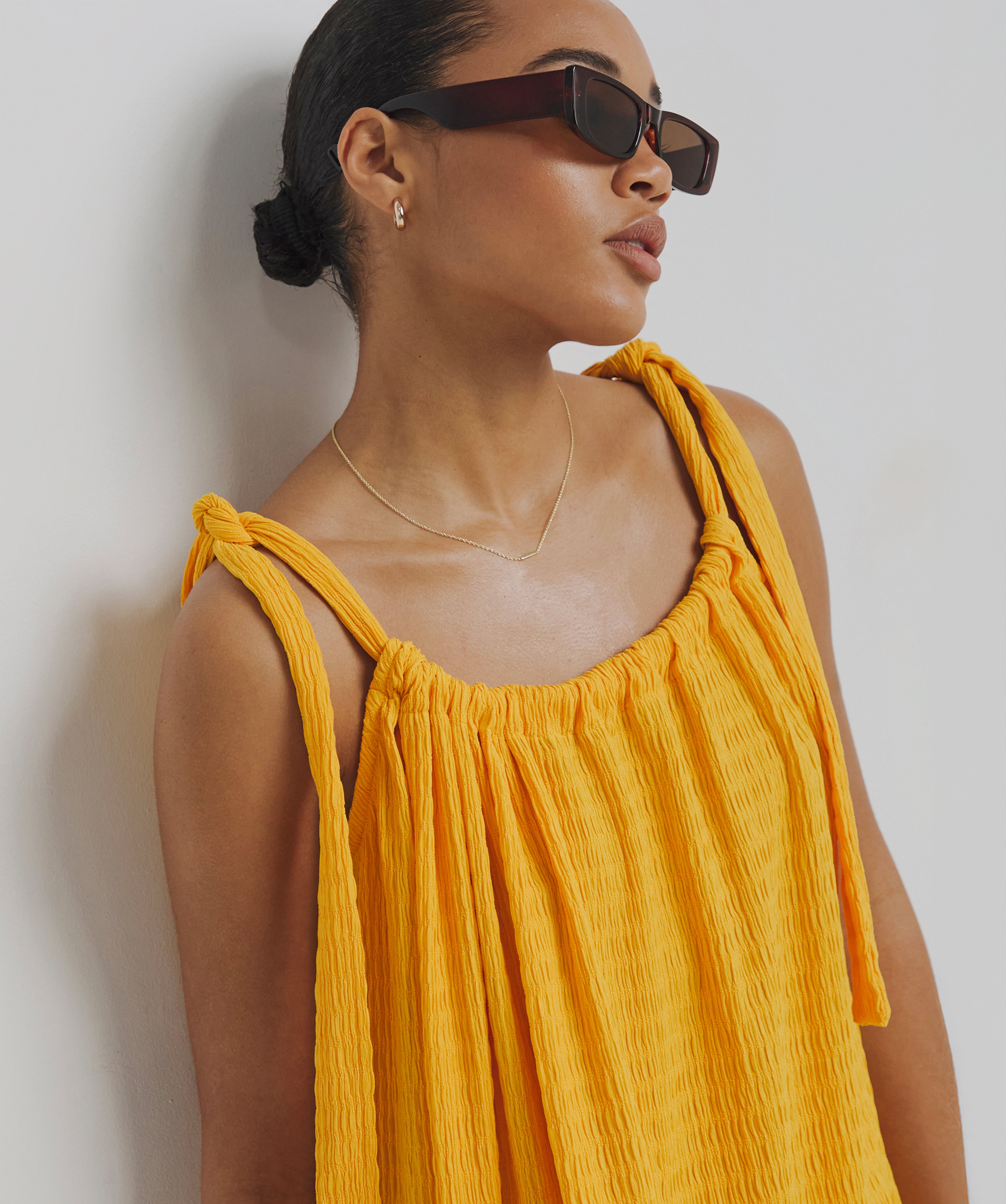 Model wears summer top in amber