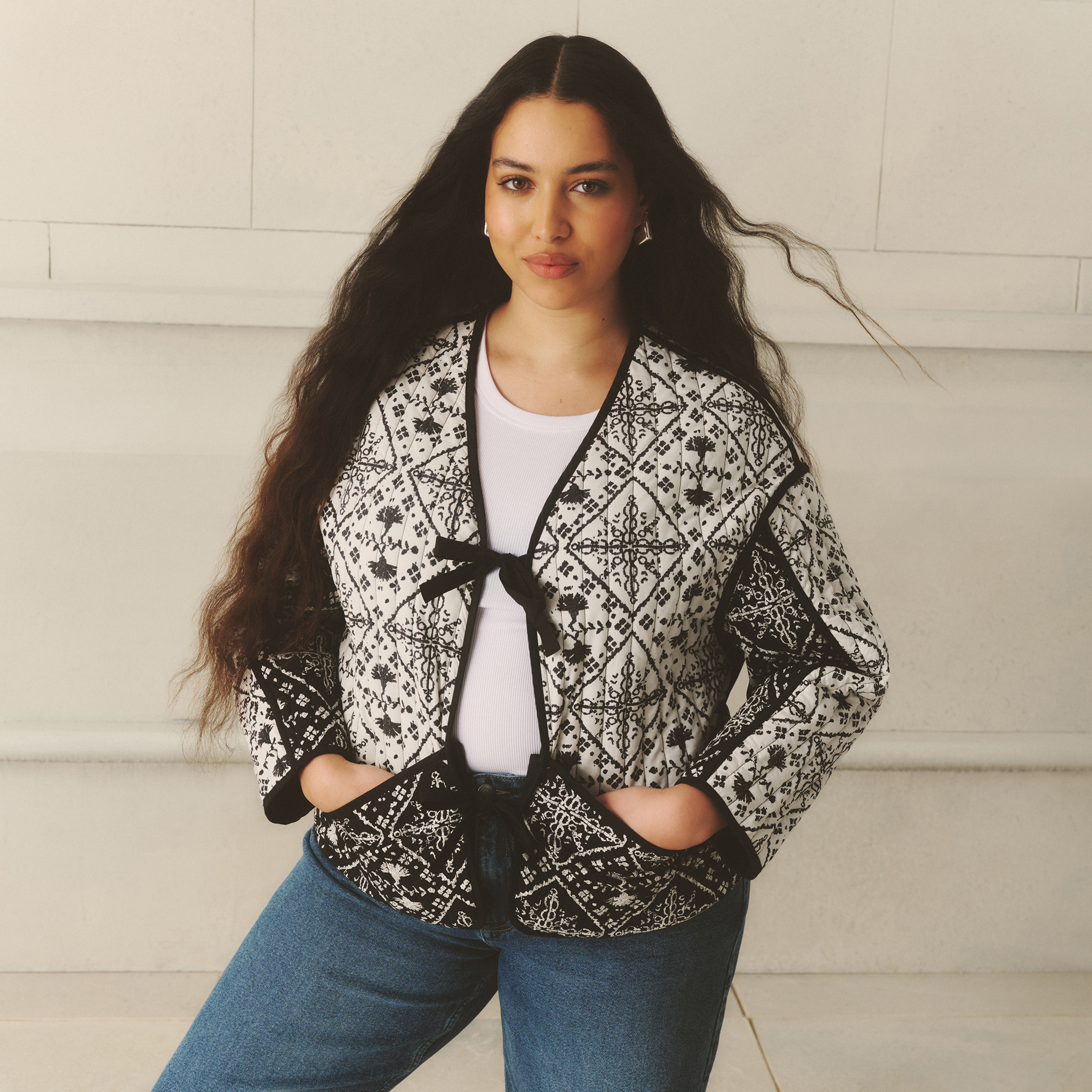 Model wears black and white quilted liner jacket