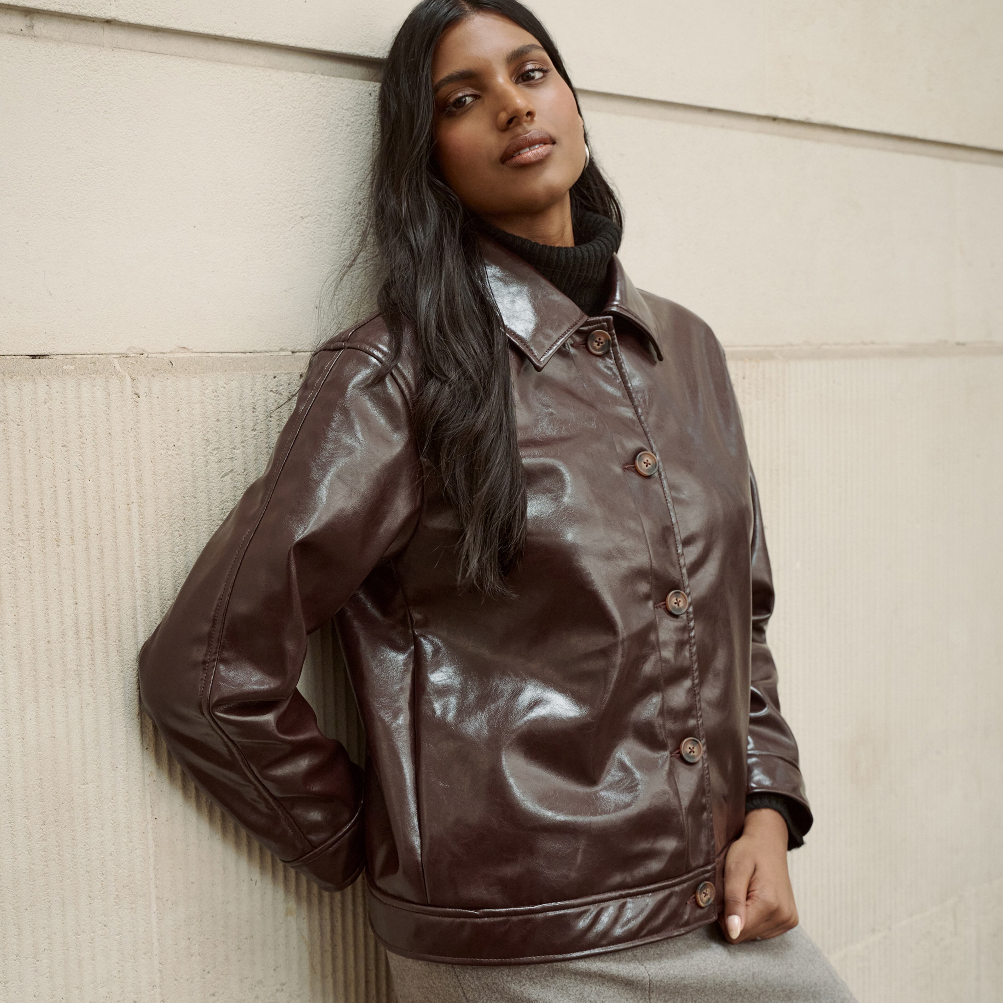 Model wears leather jacket in chocolate