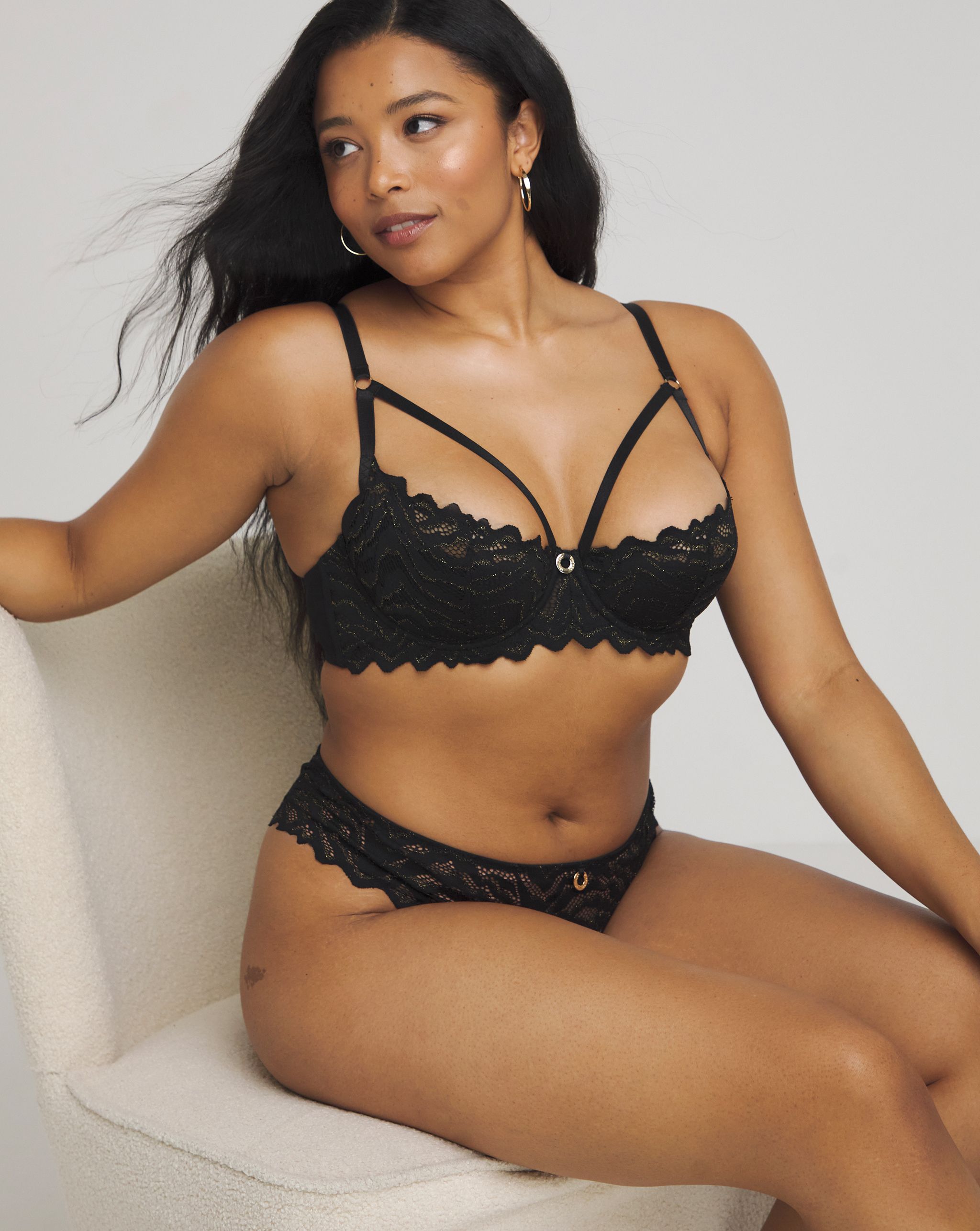 Model wearing a black bra and knickers