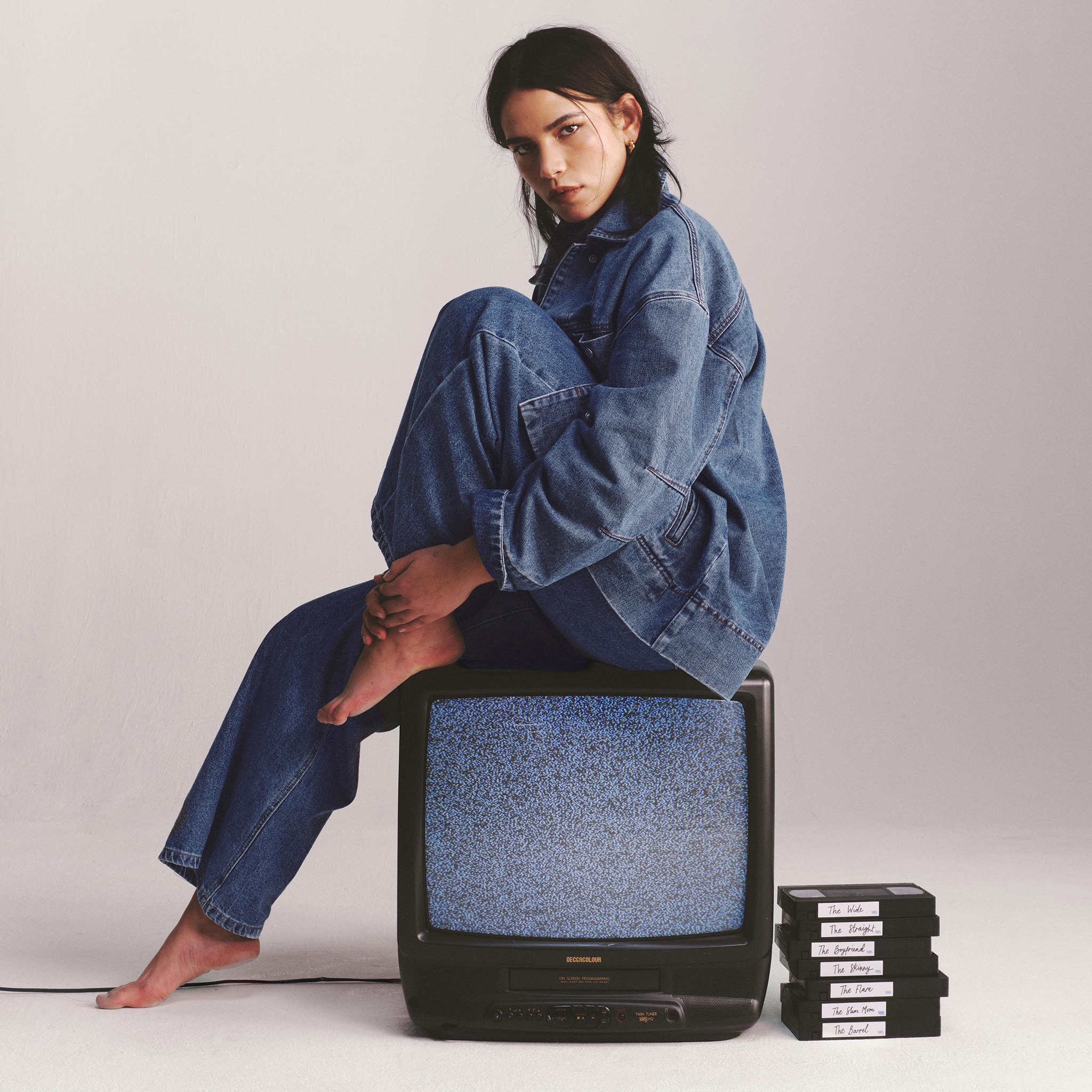 Model wears Mid Blue Pleat Detail Wide Leg Jeans