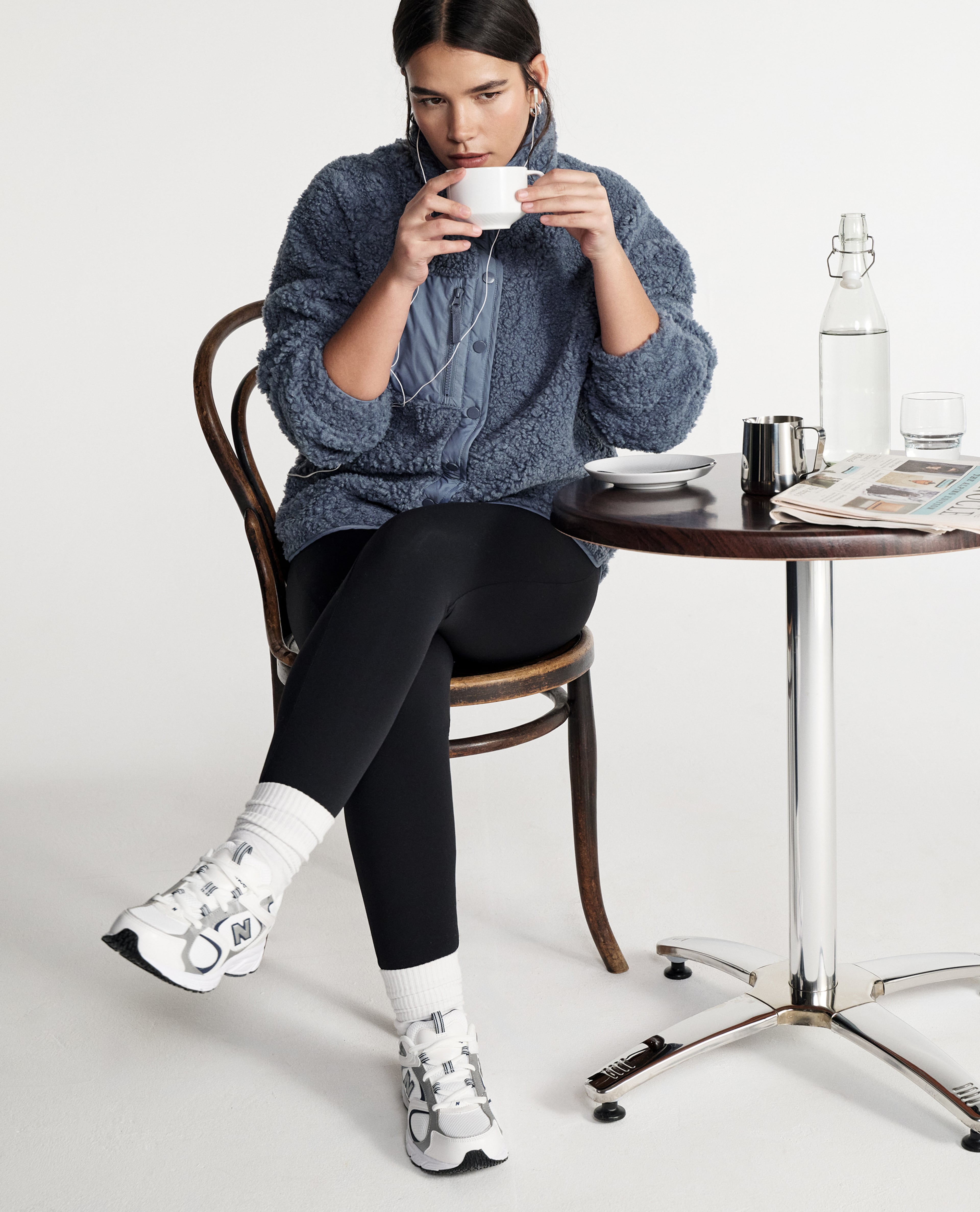 Model wears new season activewear while drinking coffee