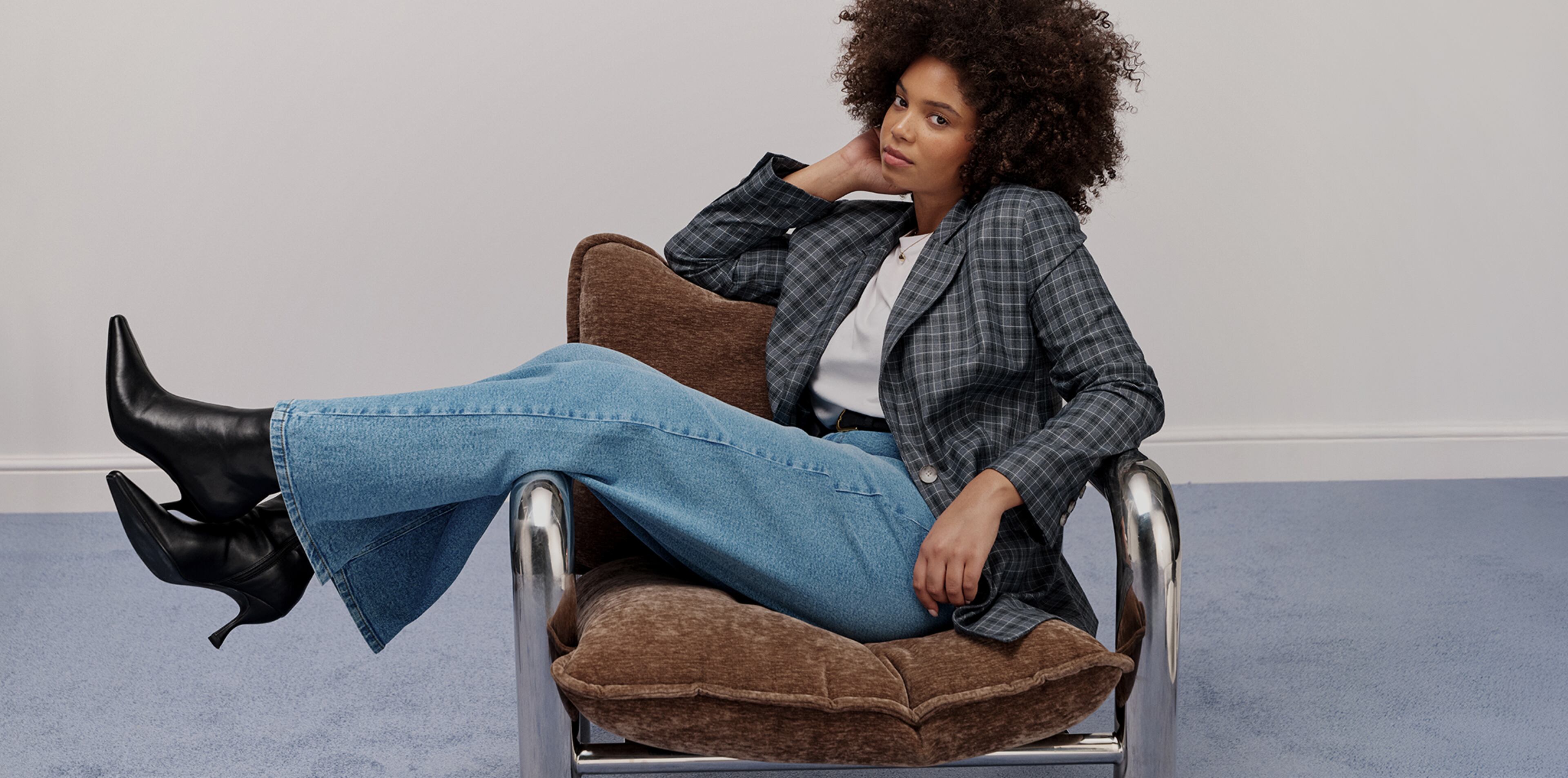 Model wears new season check blazer and jeans