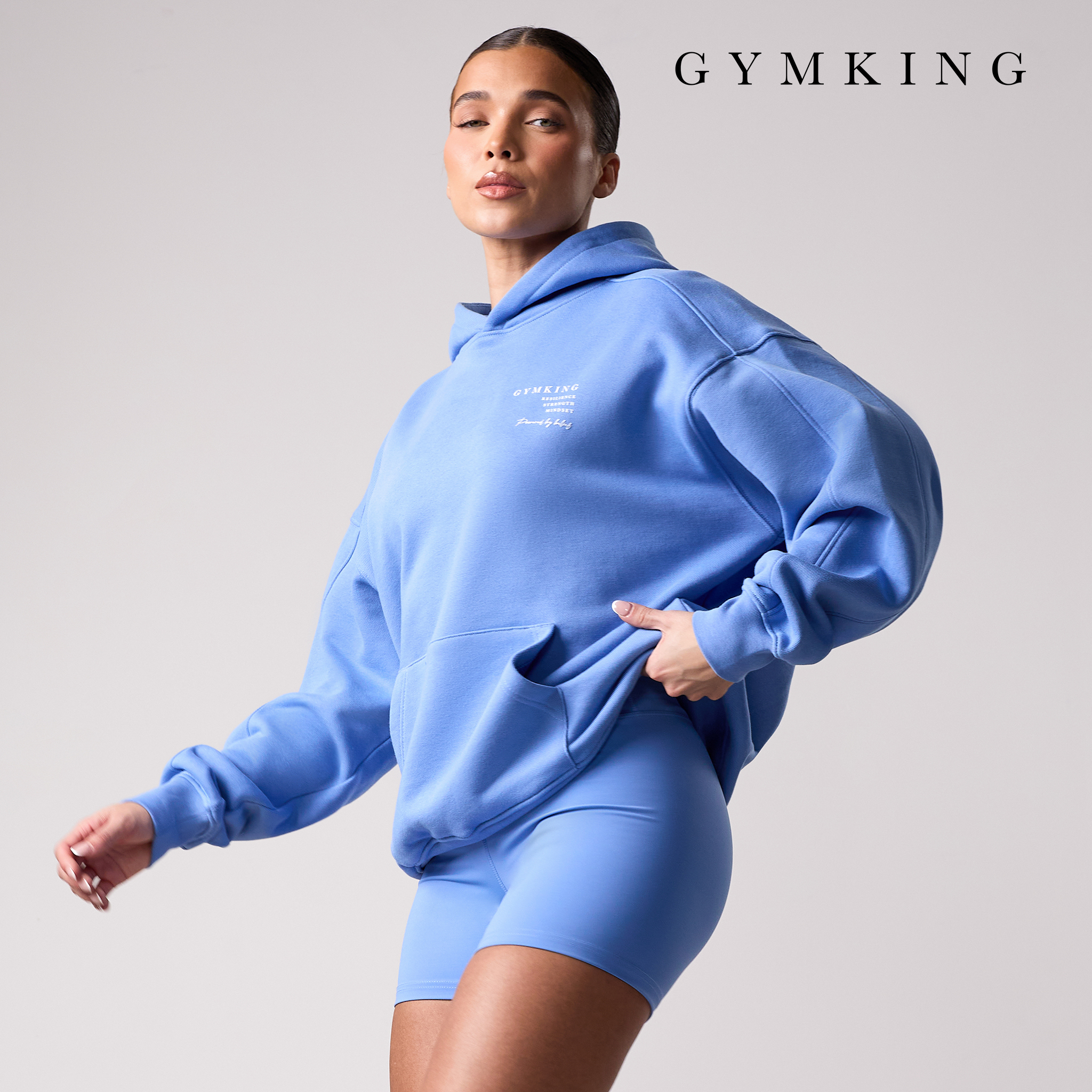 Model wears hoody and gym shorts from Gym King