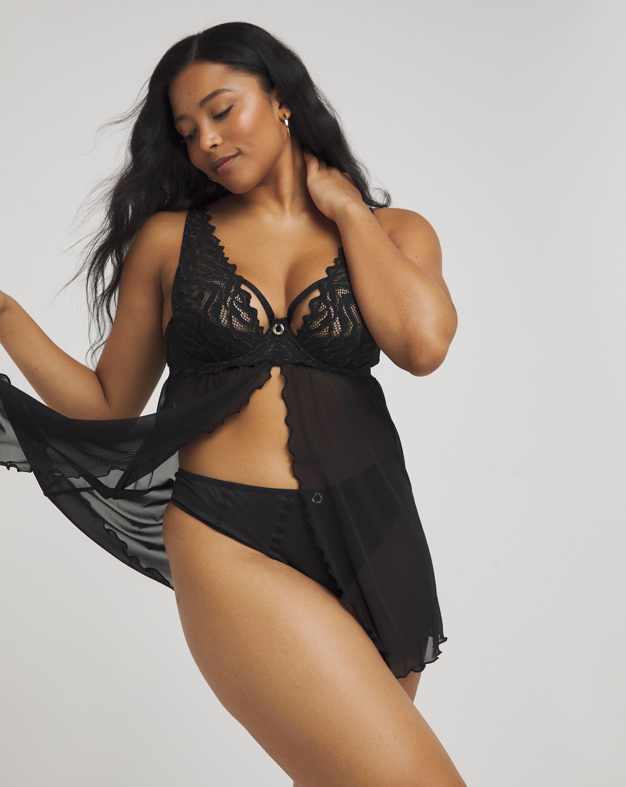 Model wearing a black lace camisole and black knickers